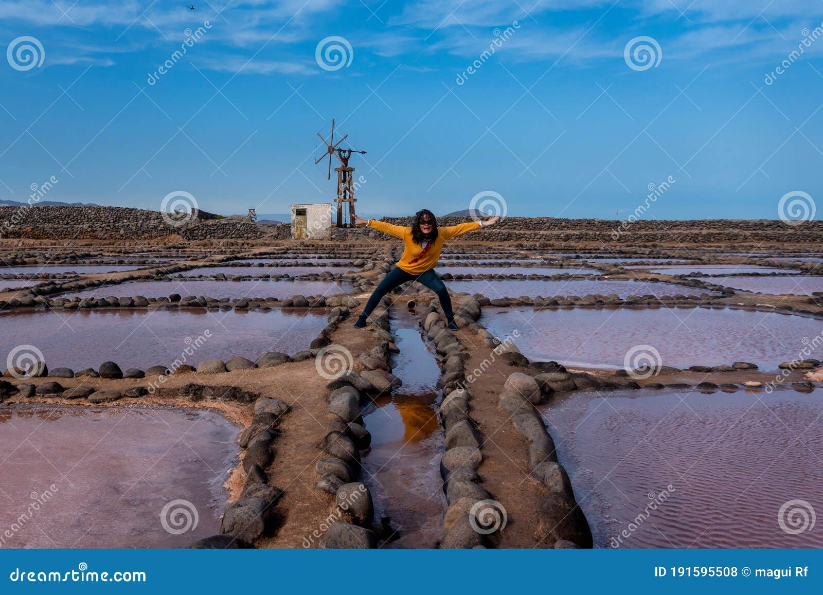 woman does funny poses in the salinas de pozo izquierdo. aguimes. gran canaria. las palmas. canary islands. 3