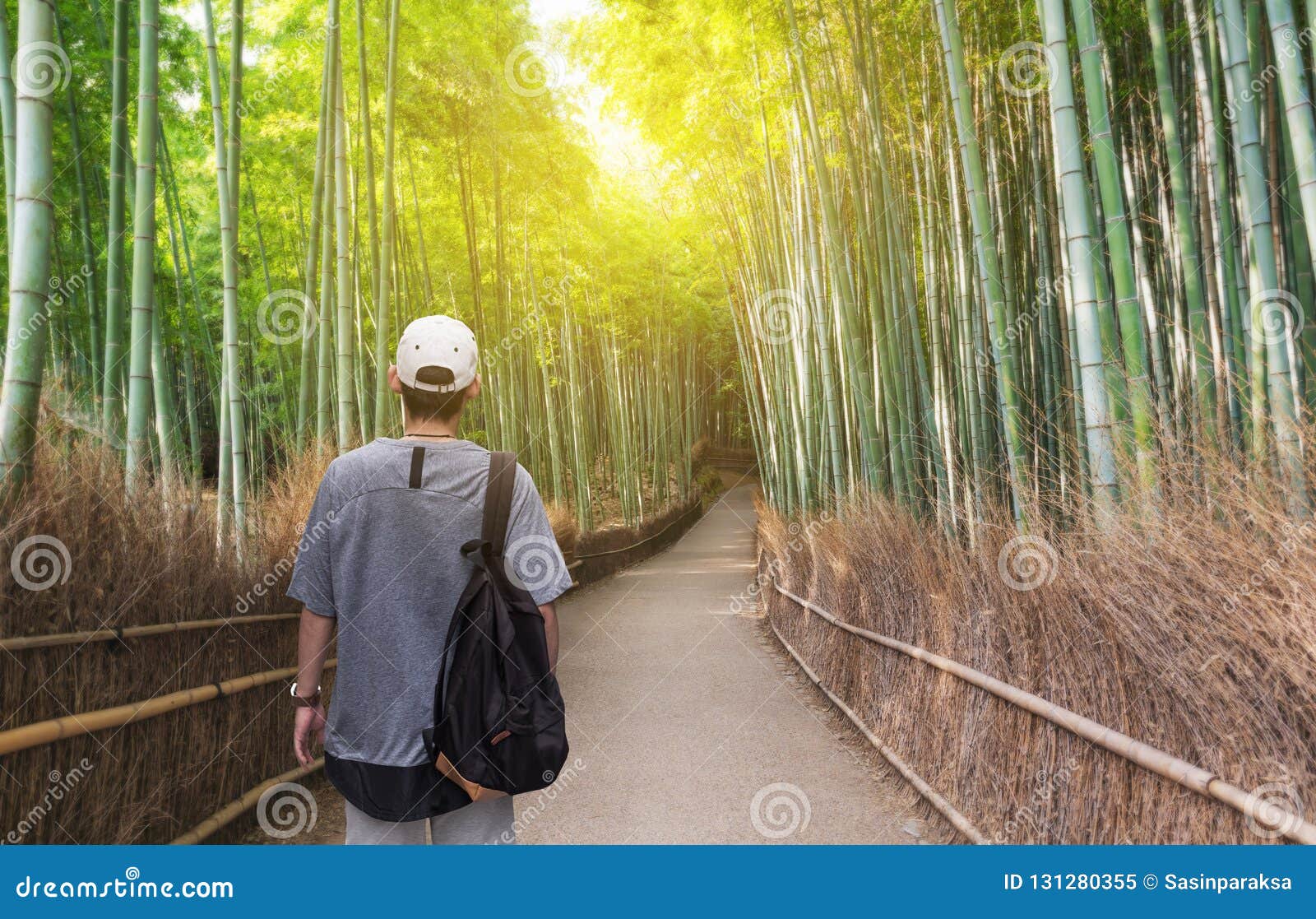 travel in japan, a man with backpack travelling at arashiyama bamboo forest, famous travel destination in kyoto japan