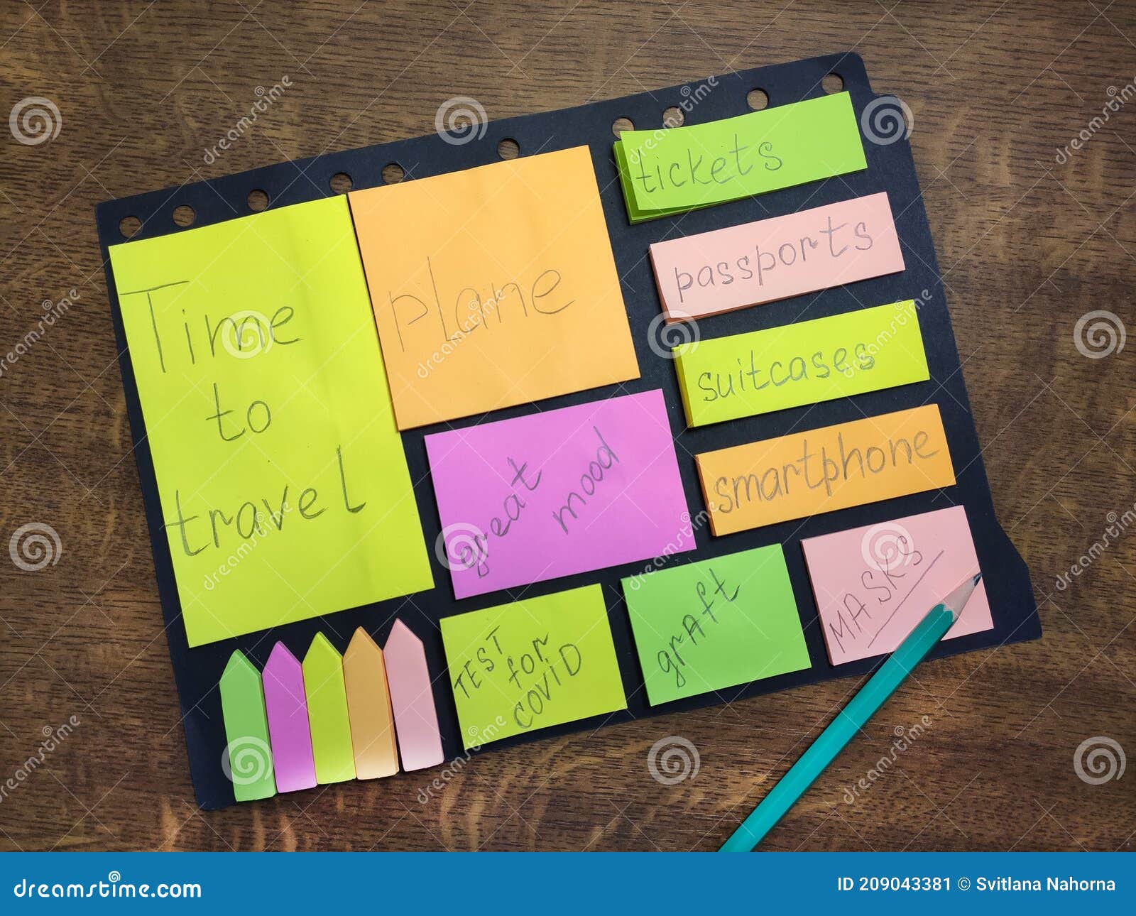 travel list. check list. multi-colored bright stickers of different sizes and pencil on a wooden background.