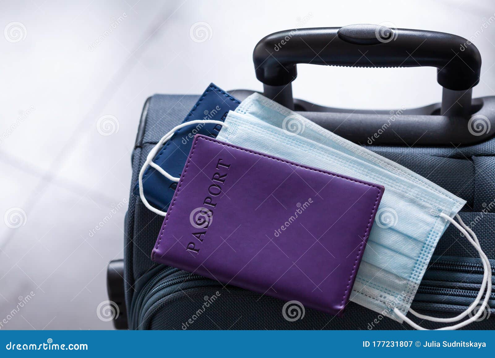 travel suitcase, passport and mask. the ban on travel during the epidemic of the coronavirus and the introduction of quarantine