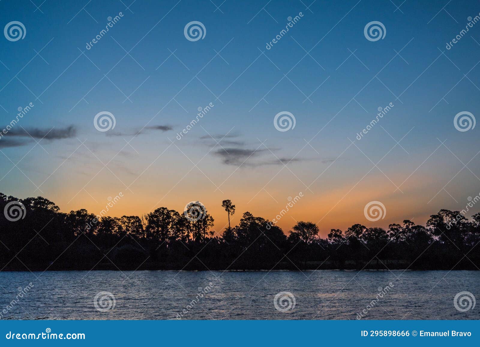 travel to a portion of river with a natural scenery of sunset over a dock with lights