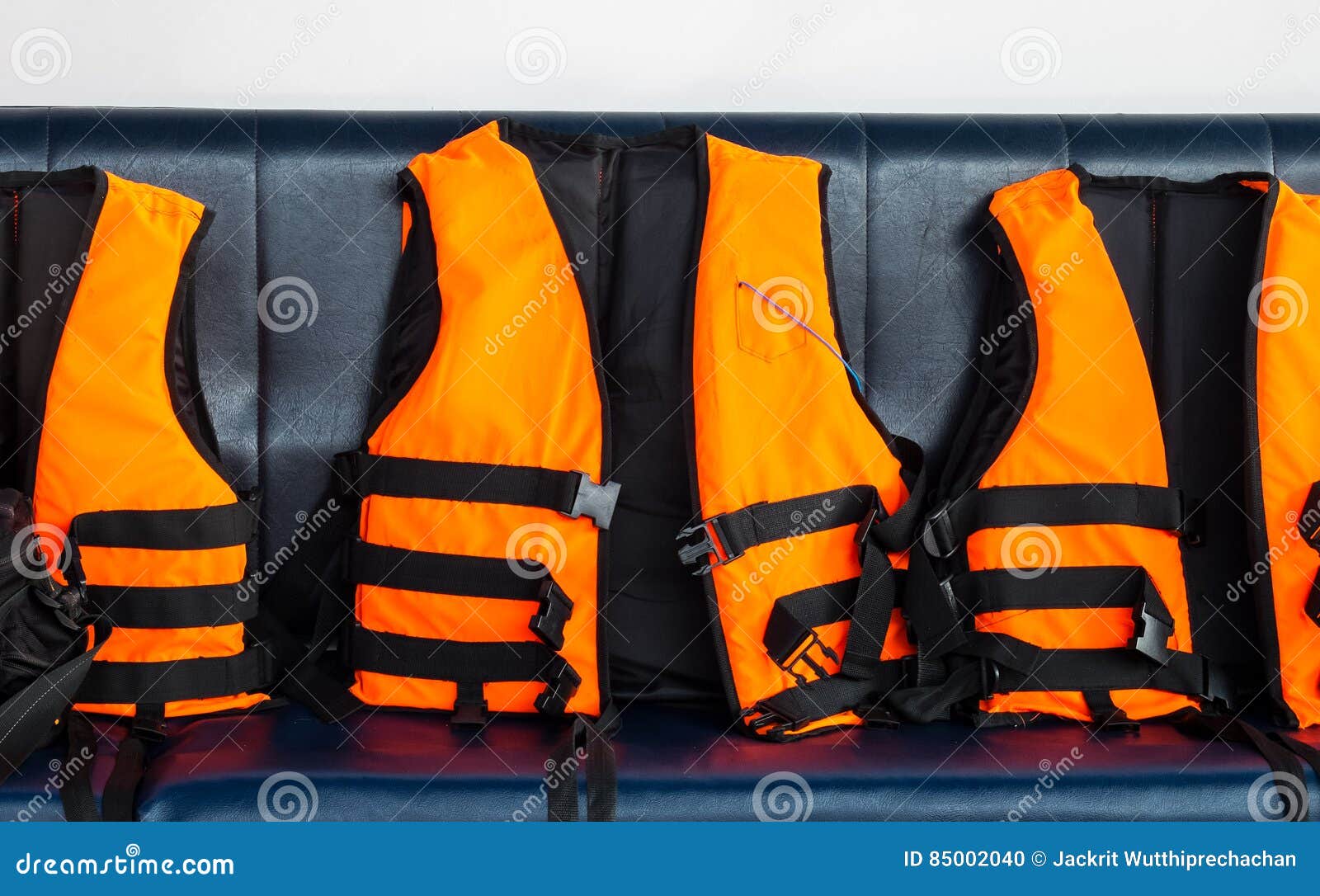 Travel To the Sea Safety. Group of Orange Life Vests on Blue Seat in ...