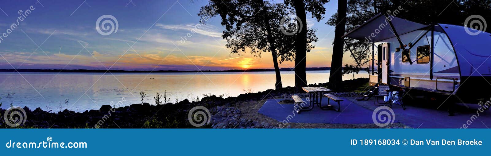 travel trailer camping by the mississippi river at sunset in illinois