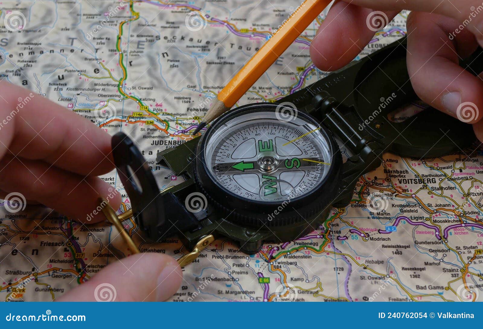 Traveler Charting a Course with Map and Compass. Compass Used for 