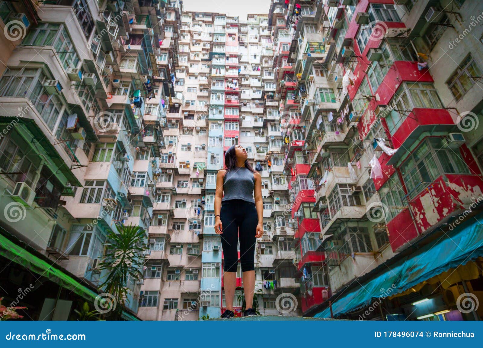 traveler exploring densely populated housing apartments in hong kong