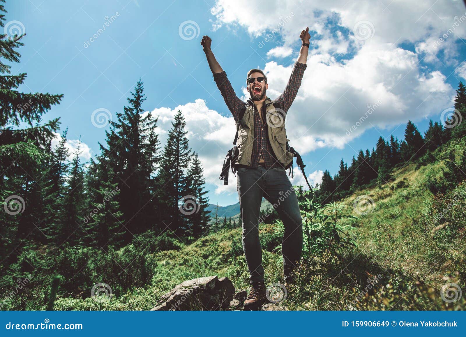 traveler man standing on green mountain hill
