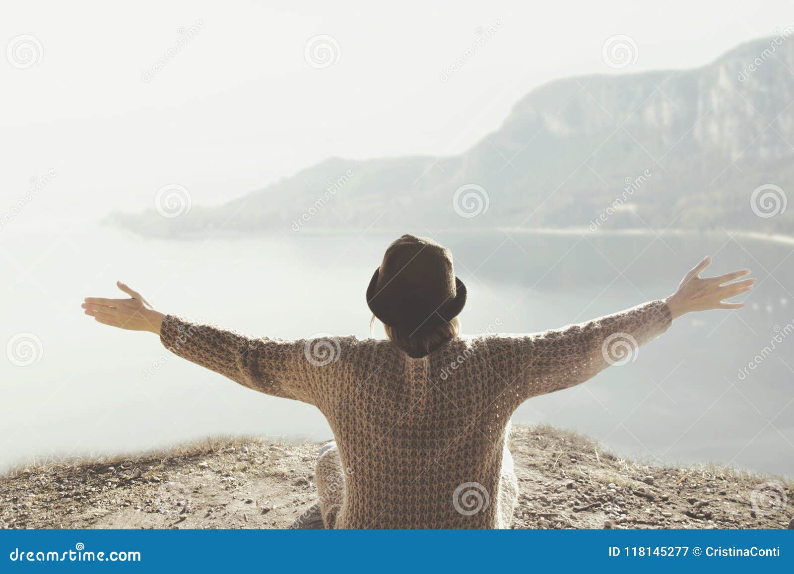 woman with open arms hugging the surrounding nature