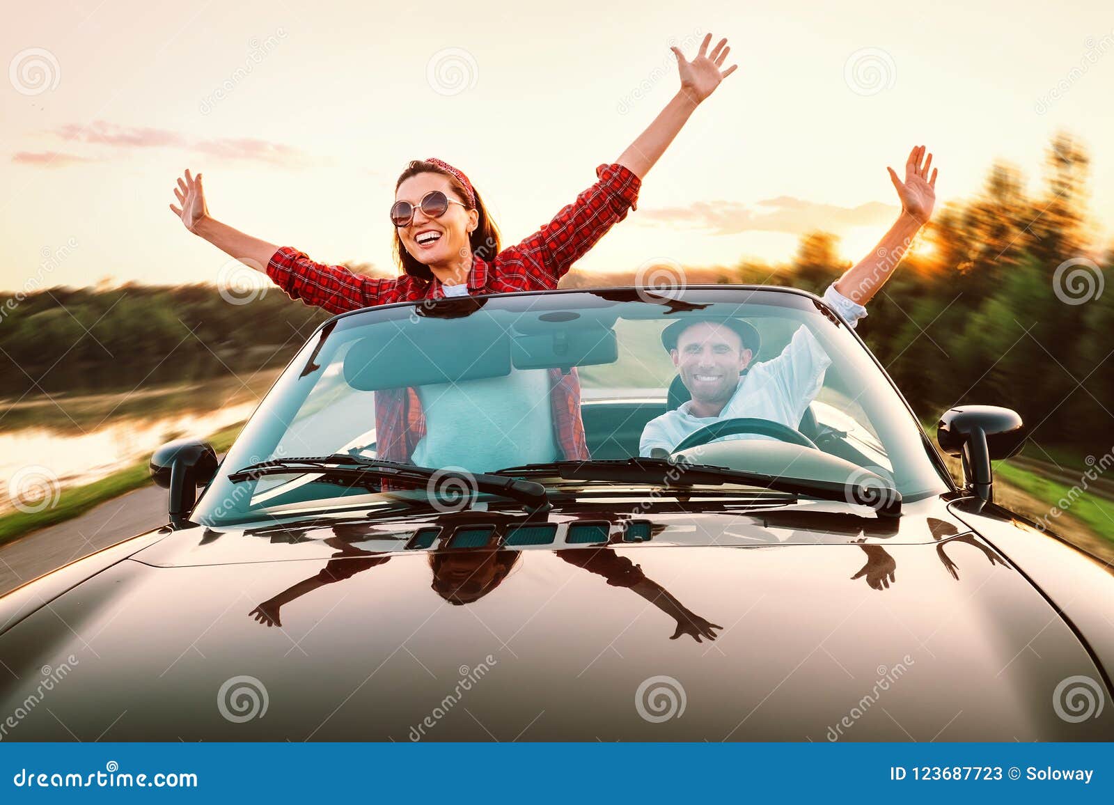 traveling by car - happy couple in love go by cabriolet car in s