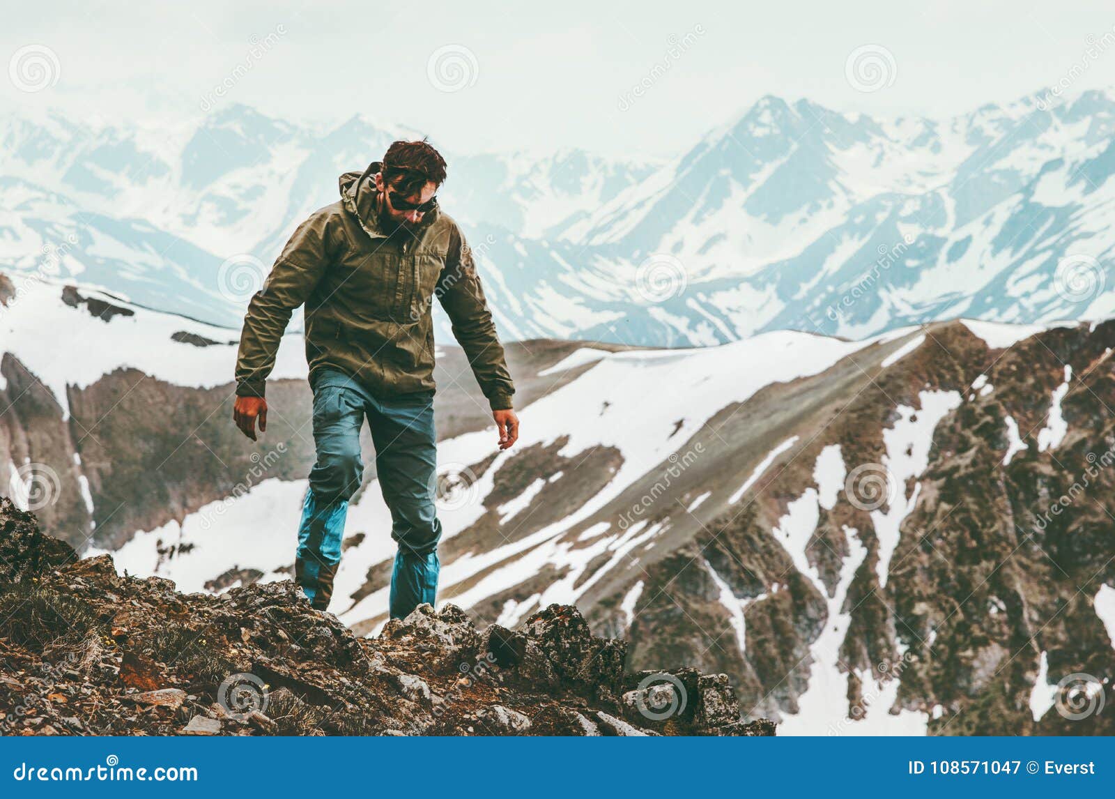 traveling man alone hiking in mountains lifestyle survival concept