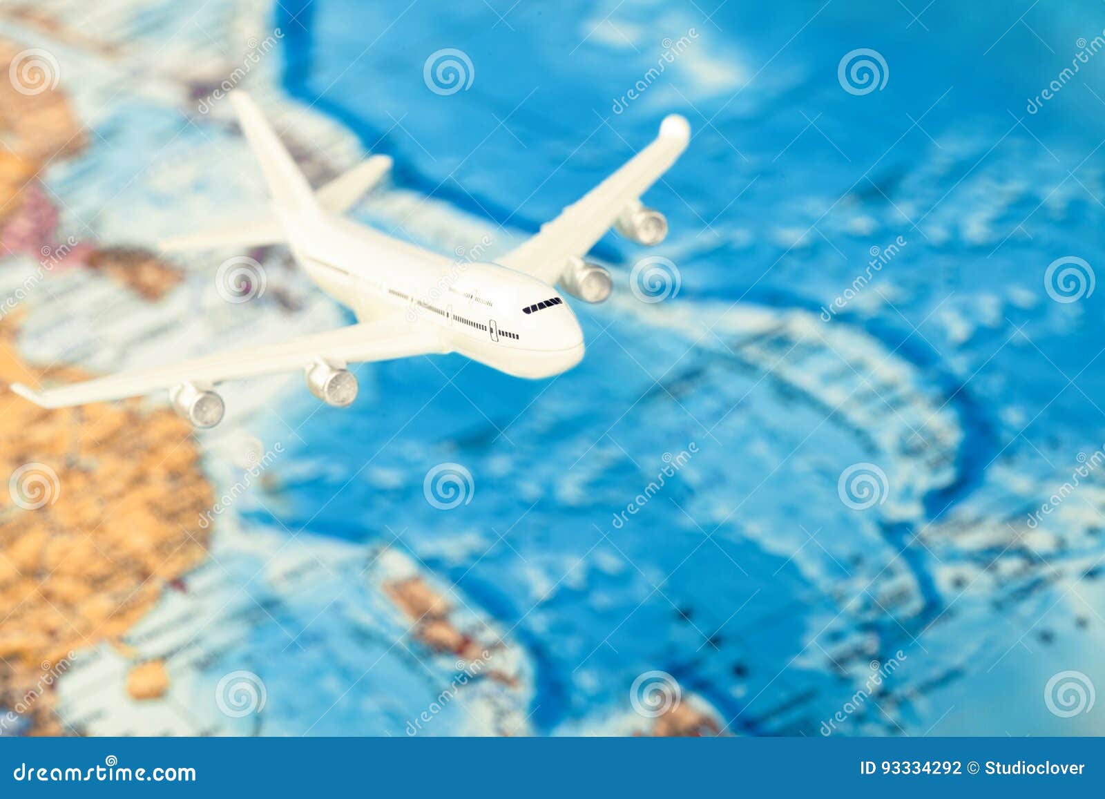 traveling, tourism and all things related series - plane over world map. filtered image: cross processed vintage effect.