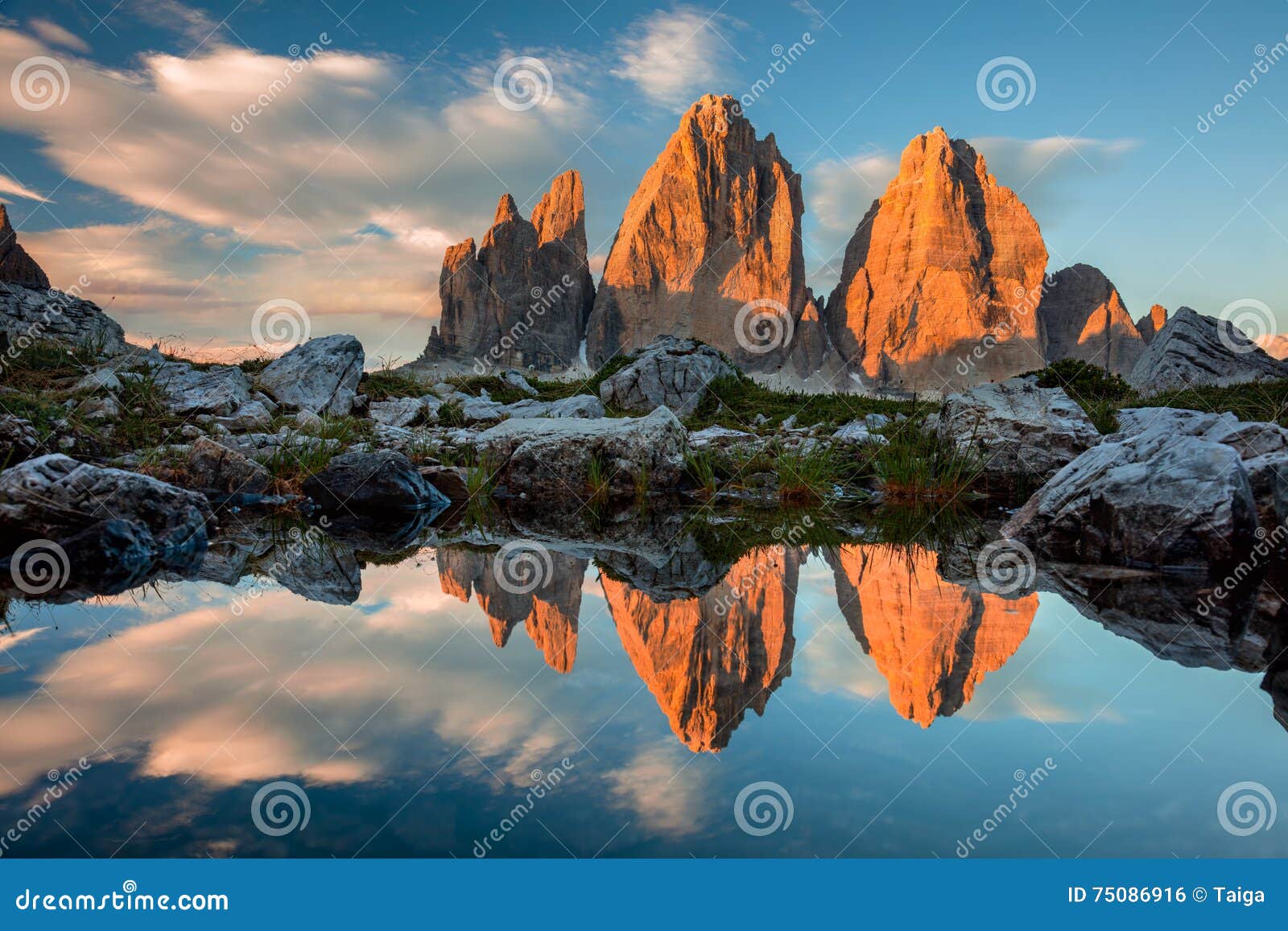 tre cime di lavaredo with reflection in lake at sundown, dolomites alps