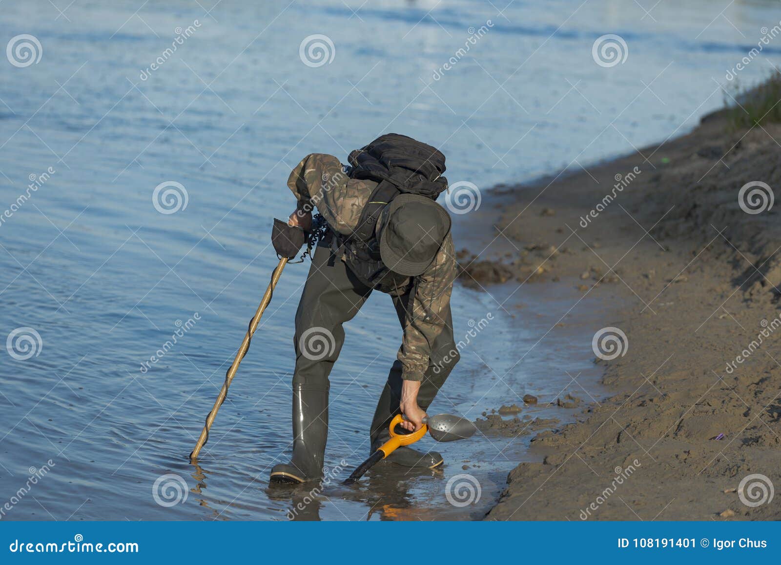 Treasure Hunter is Looking for a Metal Detector in the River Stock