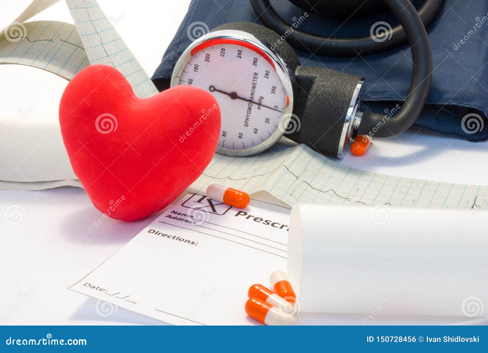 treatment of heart, hypertension and cardiovascular disease concept photo. volume model card red heart lies on table near the ekg