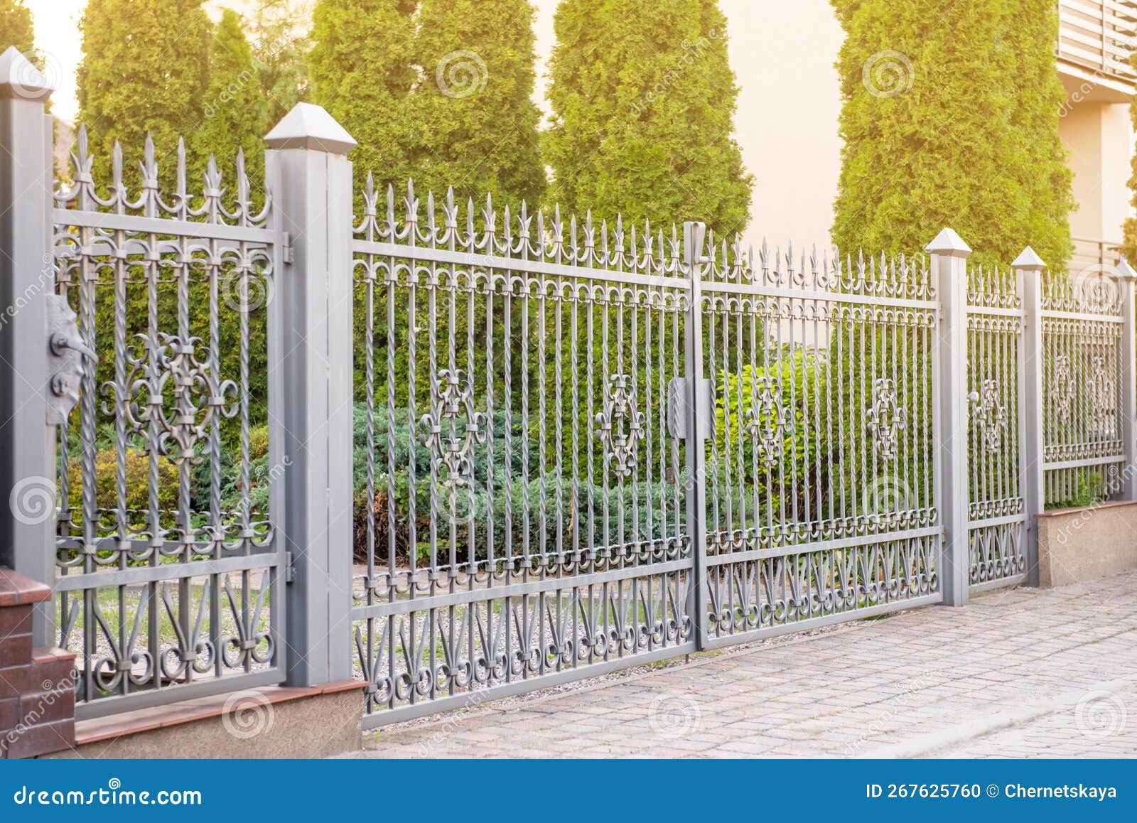 Trees Behind Beautiful Iron Fence Near Pathway Outdoors Stock Photo