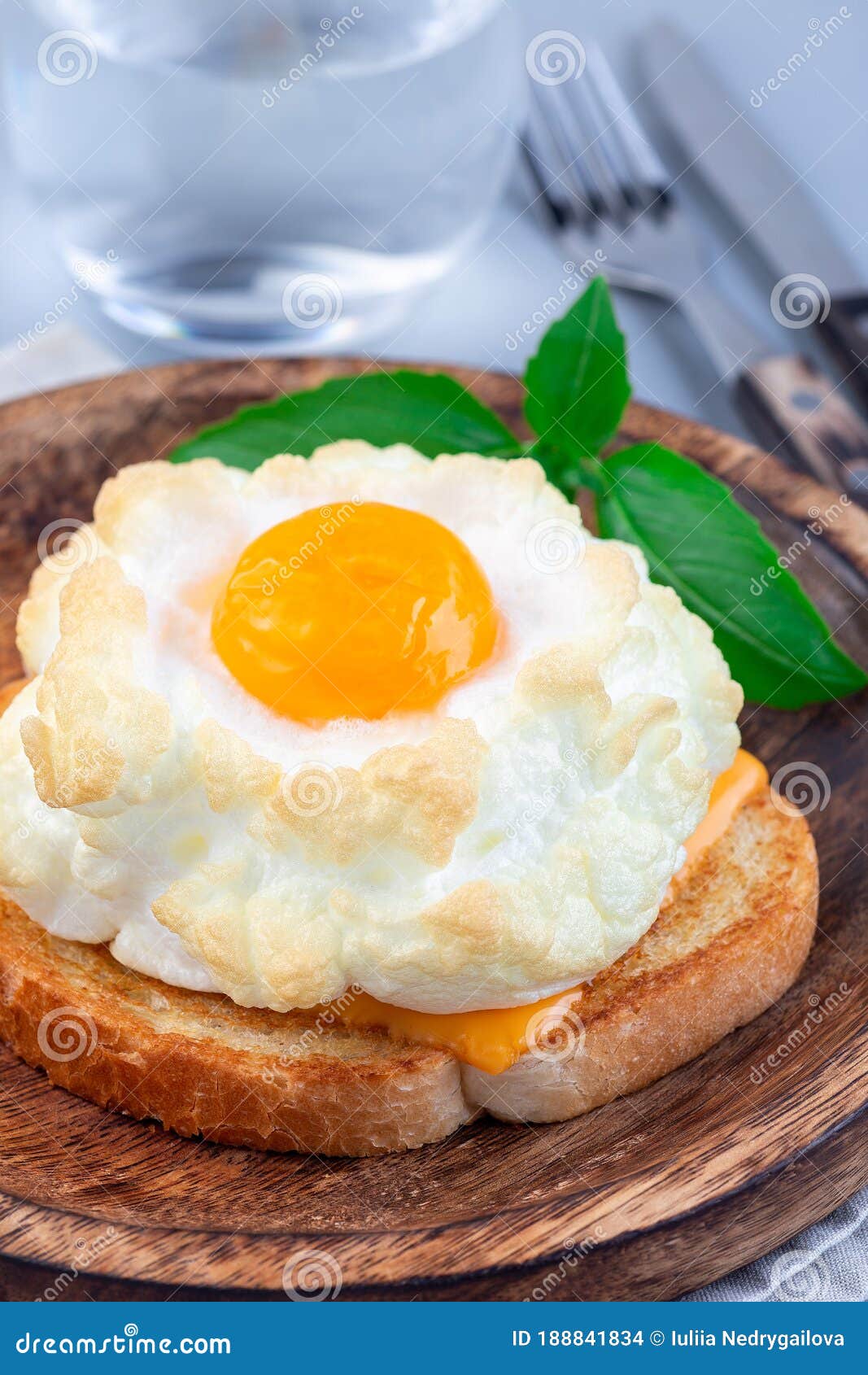 Trendy Cloud or Fluffy Egg Dish on Wooden Plate, Vertical Stock Photo