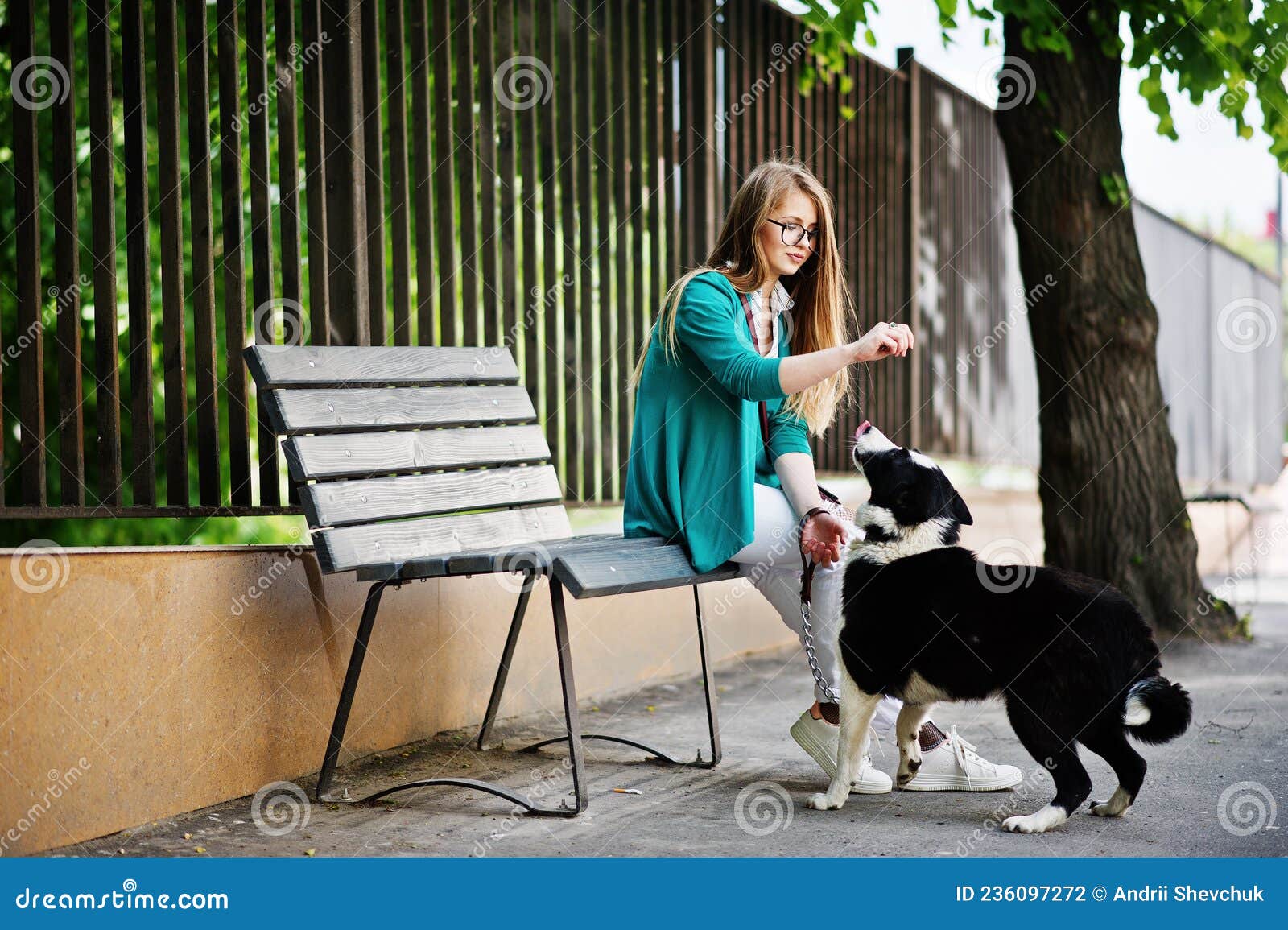 trendy girl at glasses and ripped jeans with russo-european laika husky dog