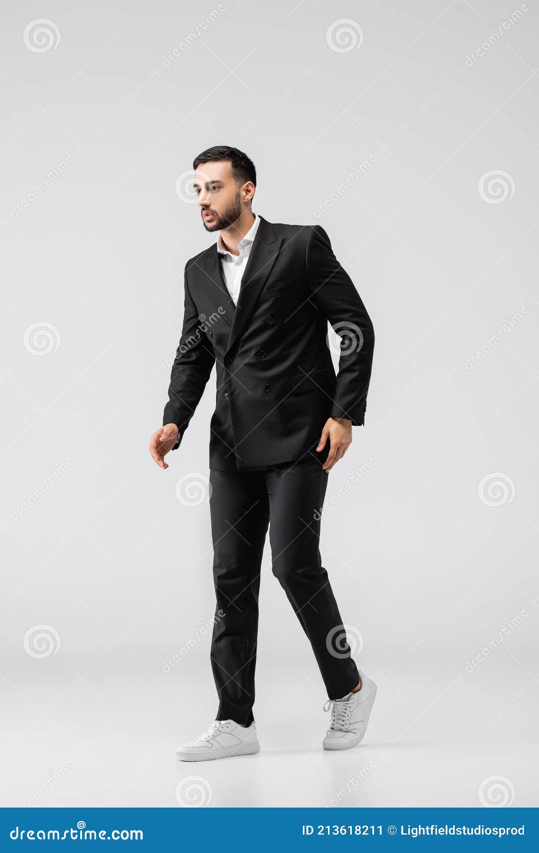 trendy muslim man black suit trendy muslim man black suit sneakers looking away walking grey stock image 213618211