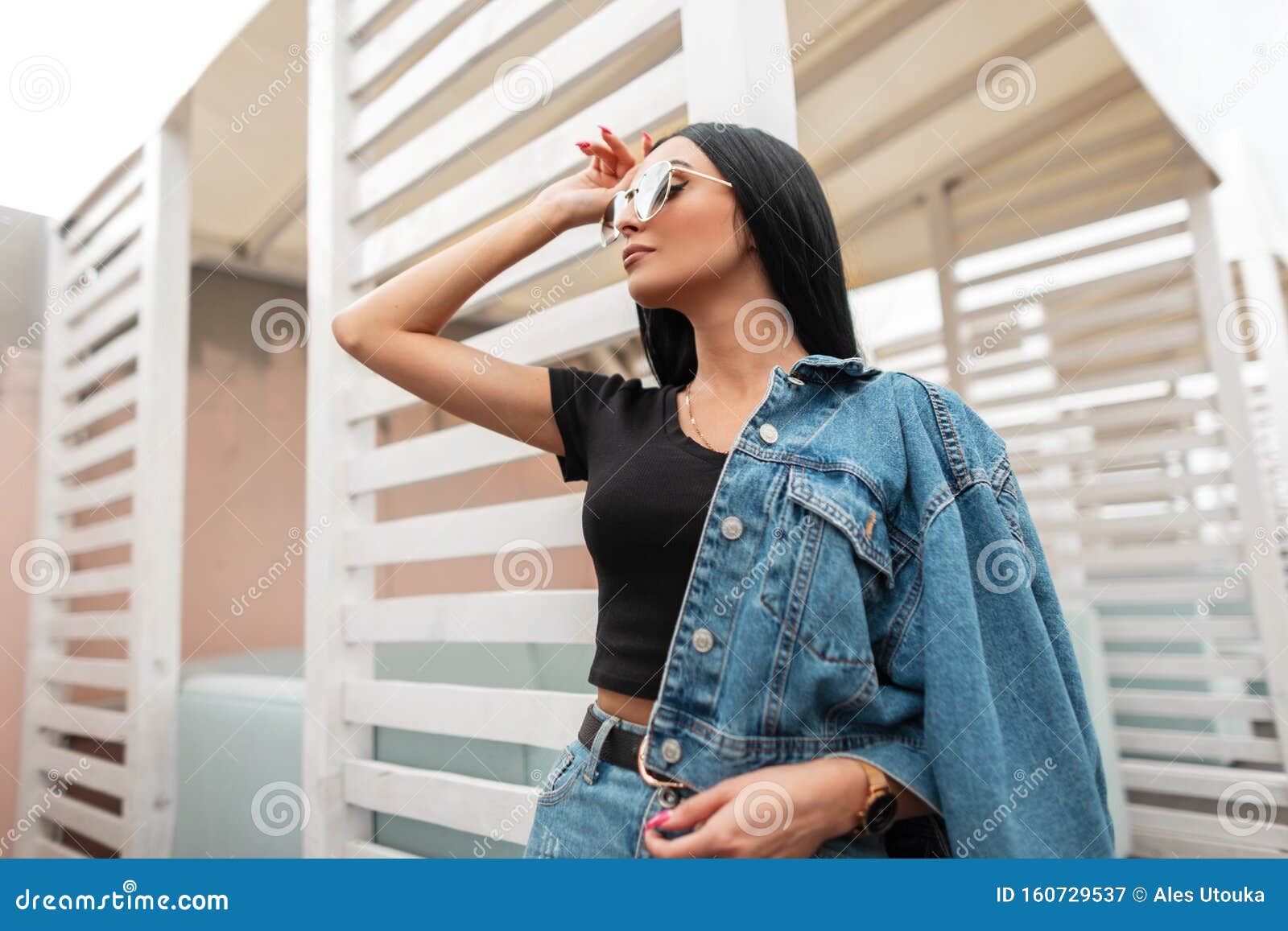 Trendy Young Woman Model with Black Long Hair in a Black T-shirt in  Fashionable Jeans Clothes in a Stylish Sunglasses. Stock Image - Image of  autumn, caucasian: 160729537