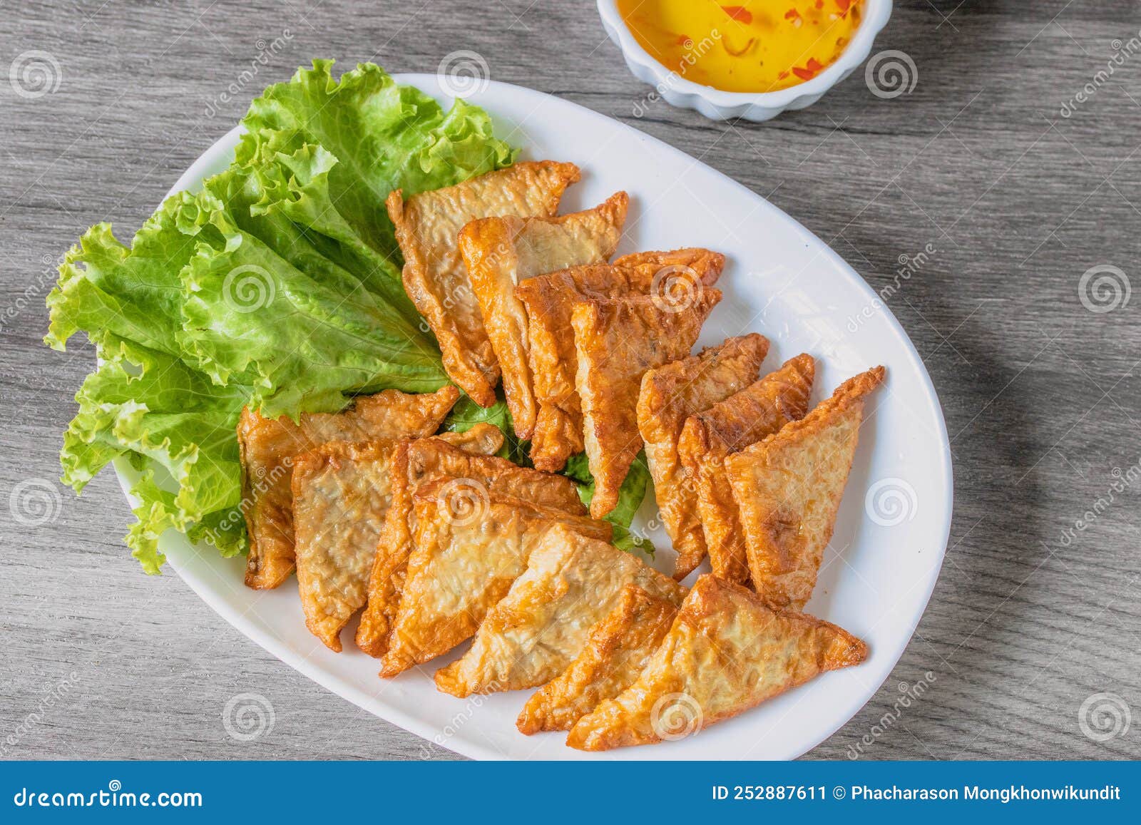 Triangular Fried Tofu Eating with Spicy Dipping Sauce, Sweet and Spicy