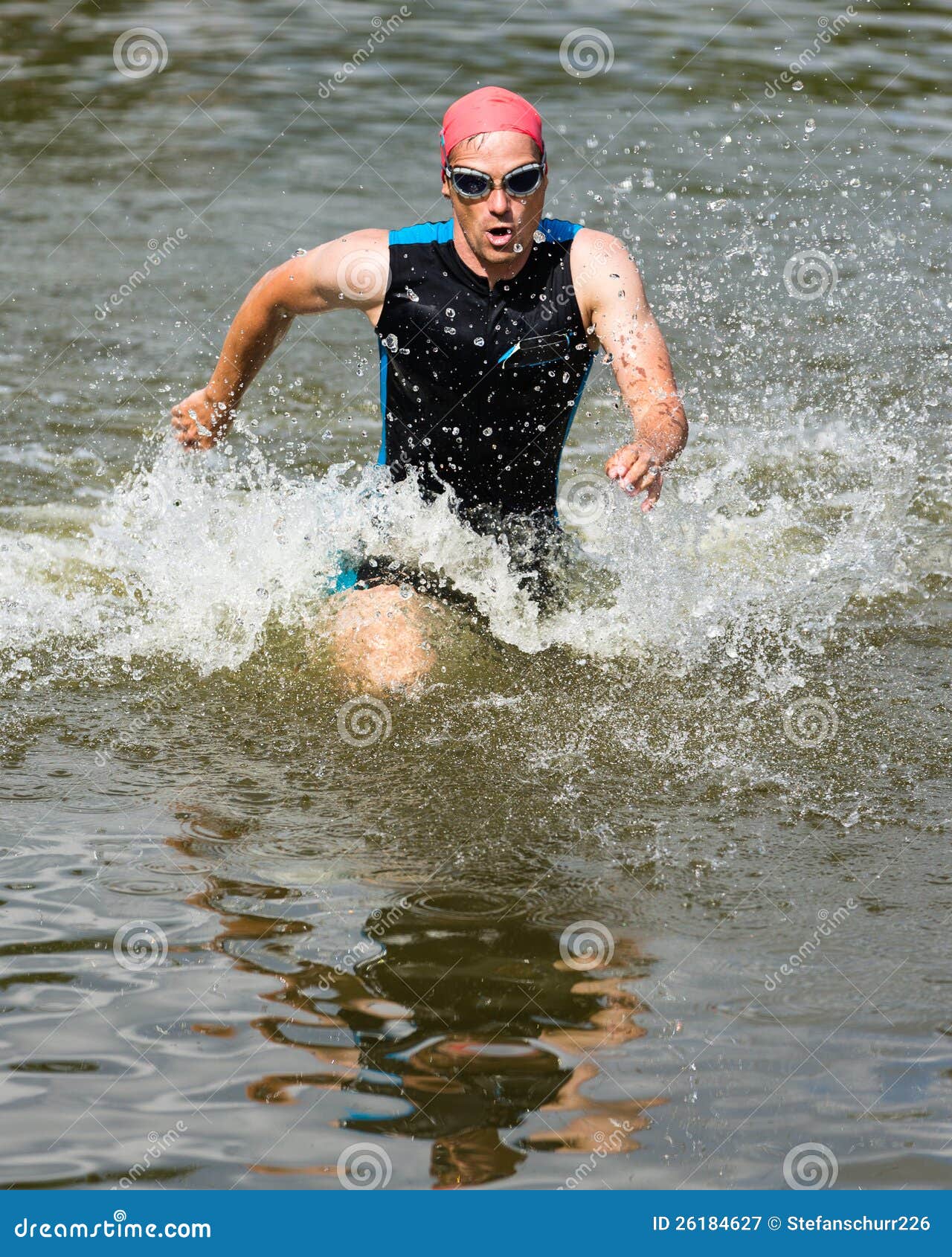 triathlete is running out ot the water