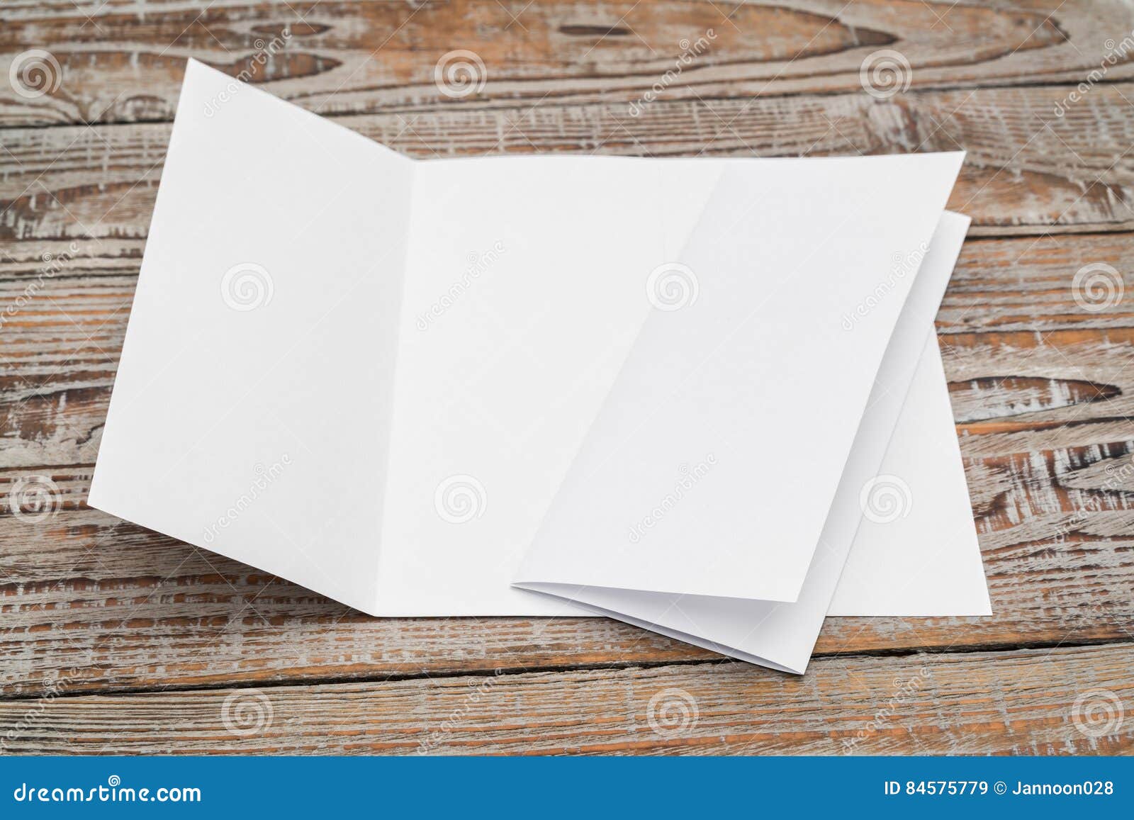 trifold white template paper on wood texture .