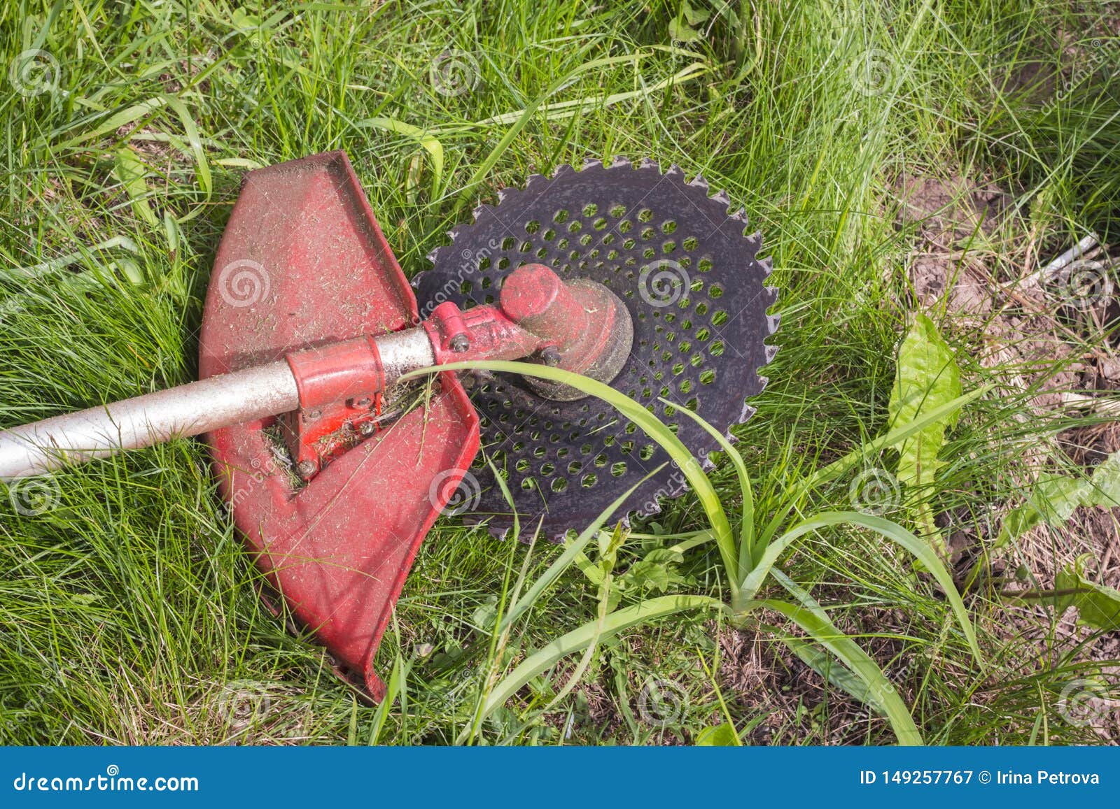 Trimmer for Cutting Grass after Work Lying on the Ground Stock Image