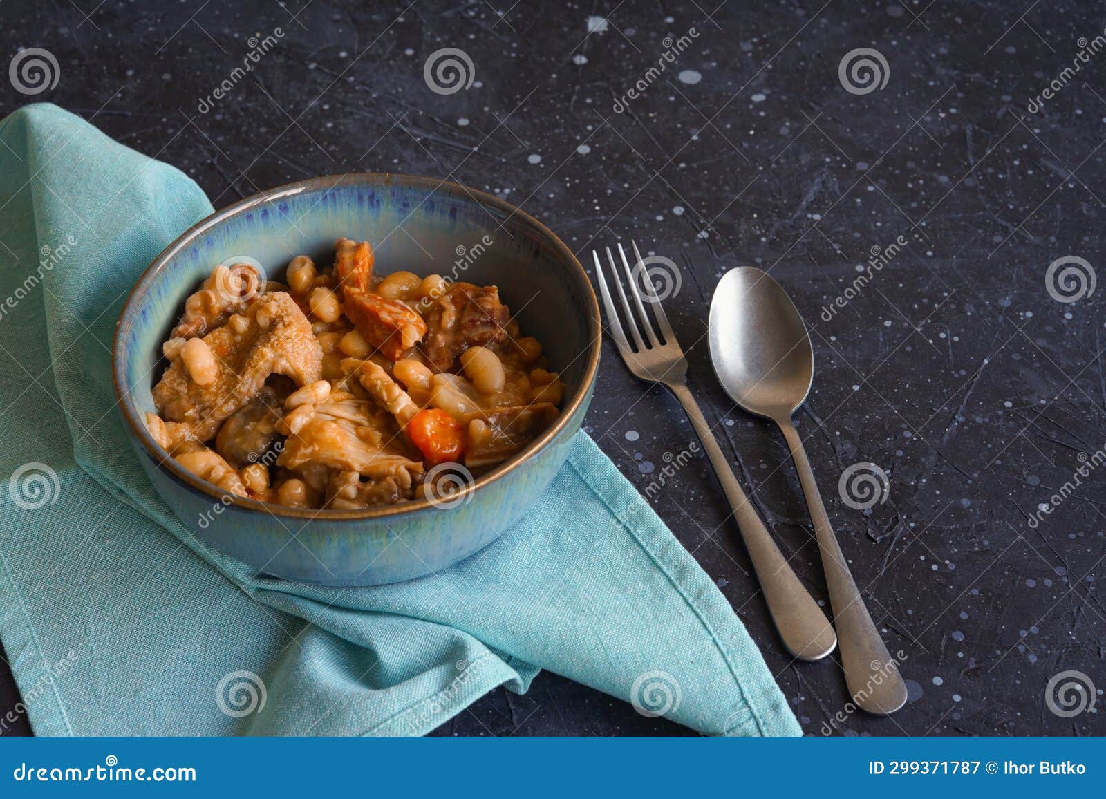 tripas- tripe stew with bread on the black background