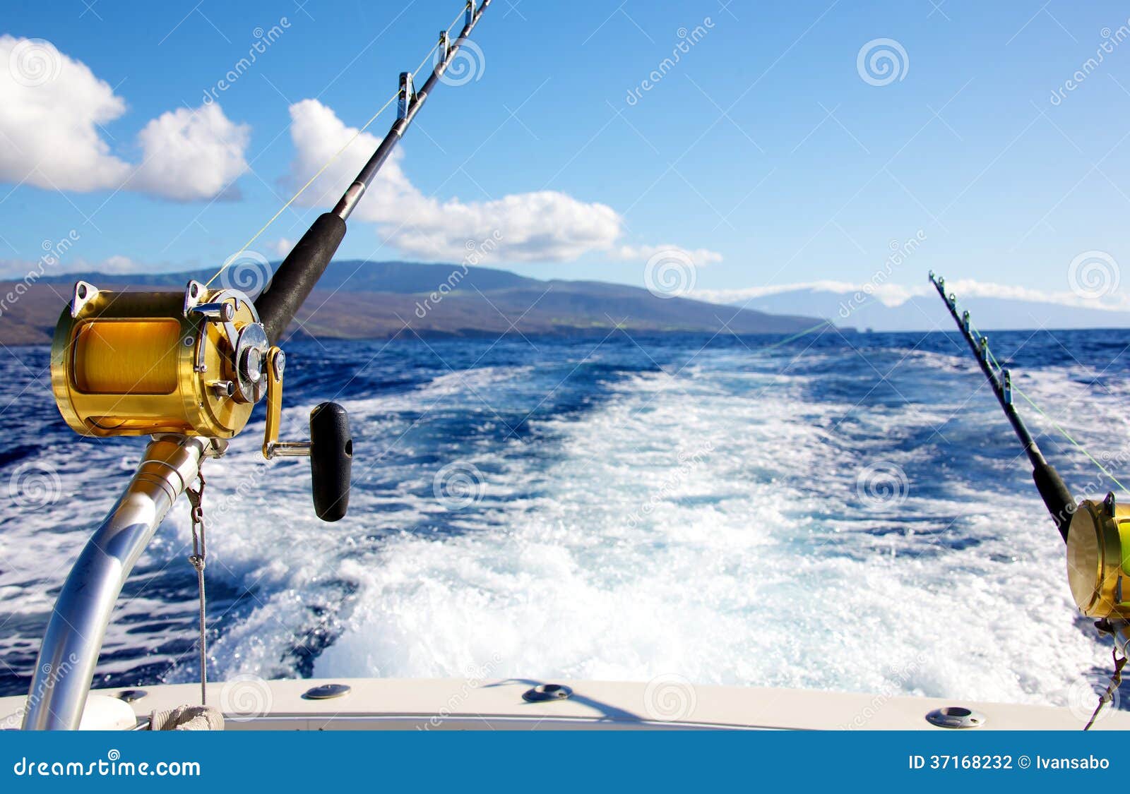 Multiplier fishing reel by the boat on ocean background Stock Photo