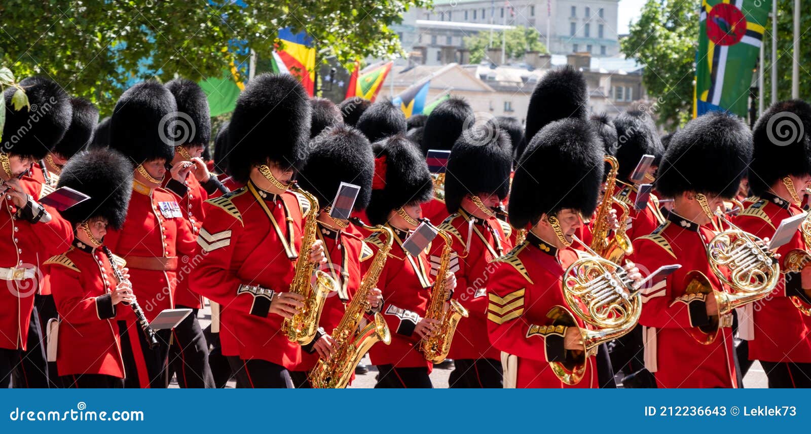 trooping the colour military band, photographed in london, uk. guards wear red and black traditional uniform with bearskin hats.