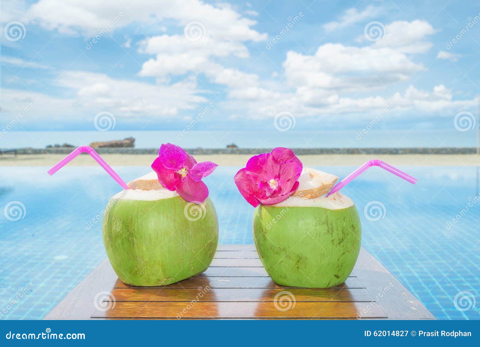 tropical fresh coconut cocktail with pool and beach in ocean, phuket ,thailand