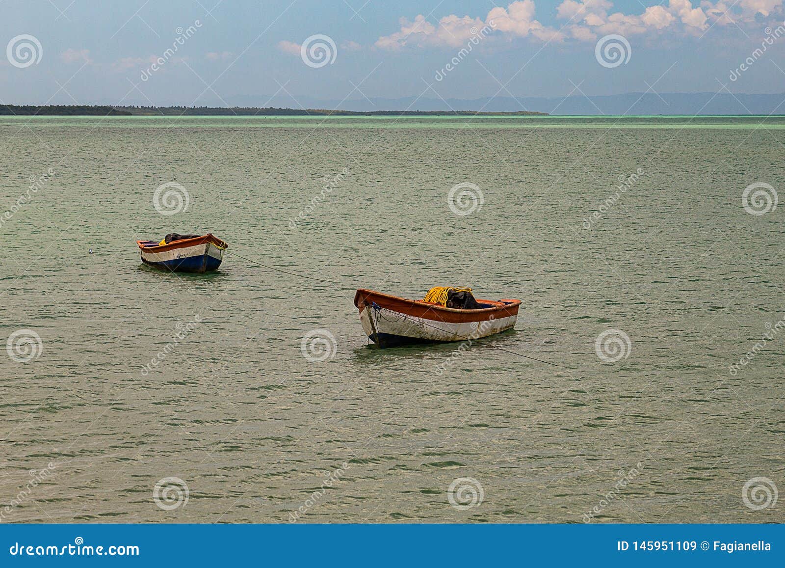 tropical paradise typical scenery: colored wooden boats docked in the sea. miches bay or sabana de la mar lagoon, northern