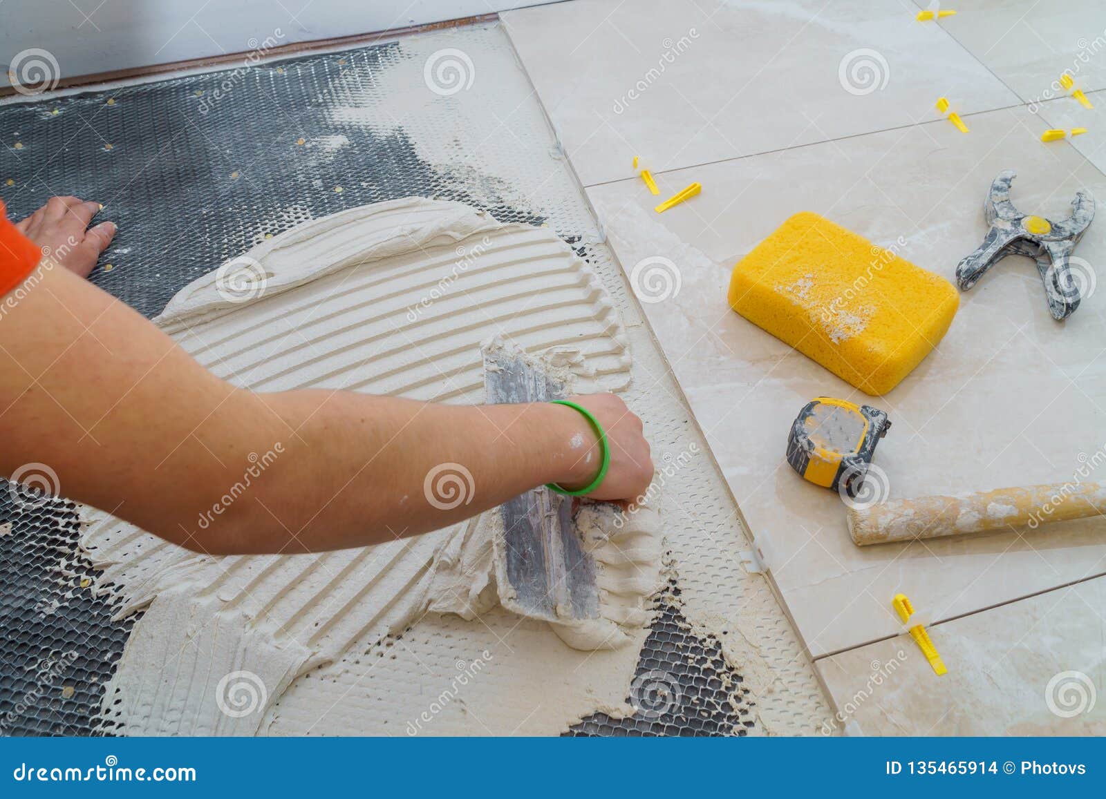 Troweling Mortar Onto A Concrete Floor In Preparation For Floor