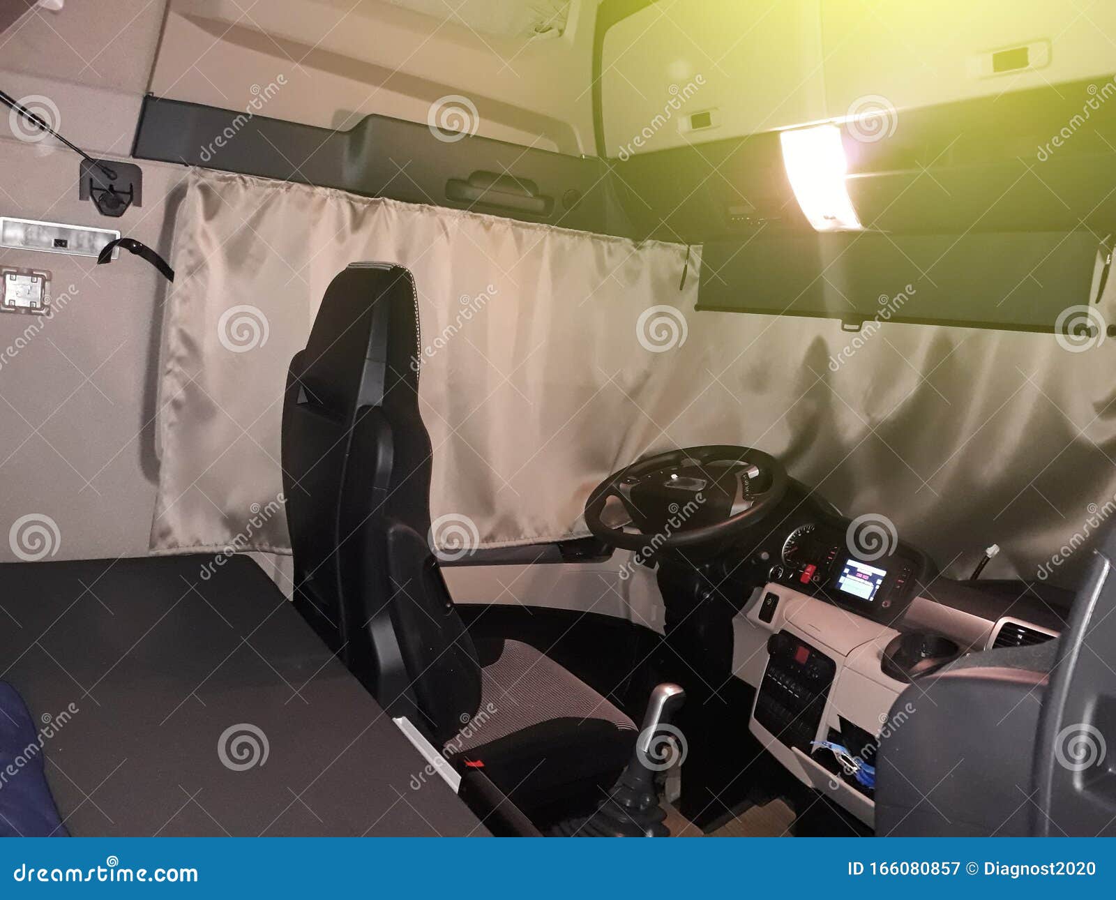a truck driver is going to sleep in his cabin after working long hours on routes for a long time. the cab of the truck at night,