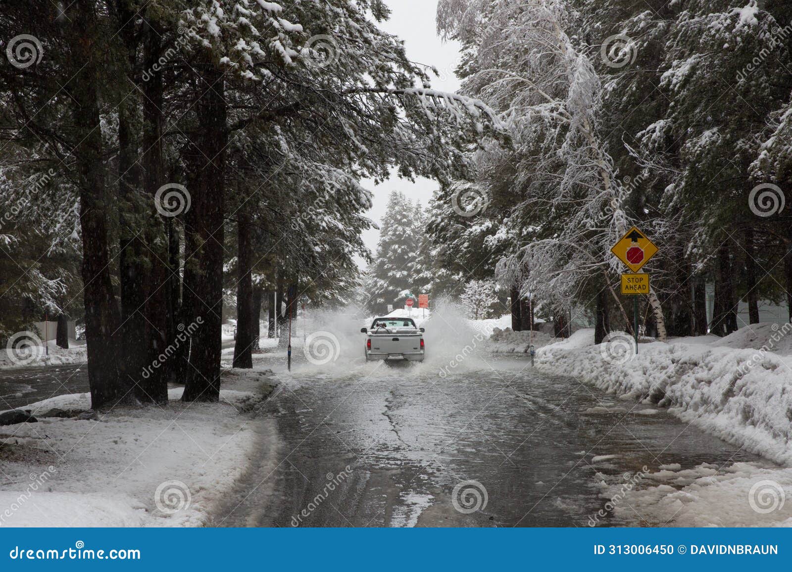 truck driving through flooded road during warm winter storm near lake tahoe