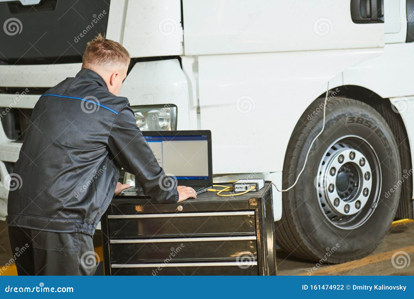 truck repair service. mechanic makes computer diagnostic of the semitruck