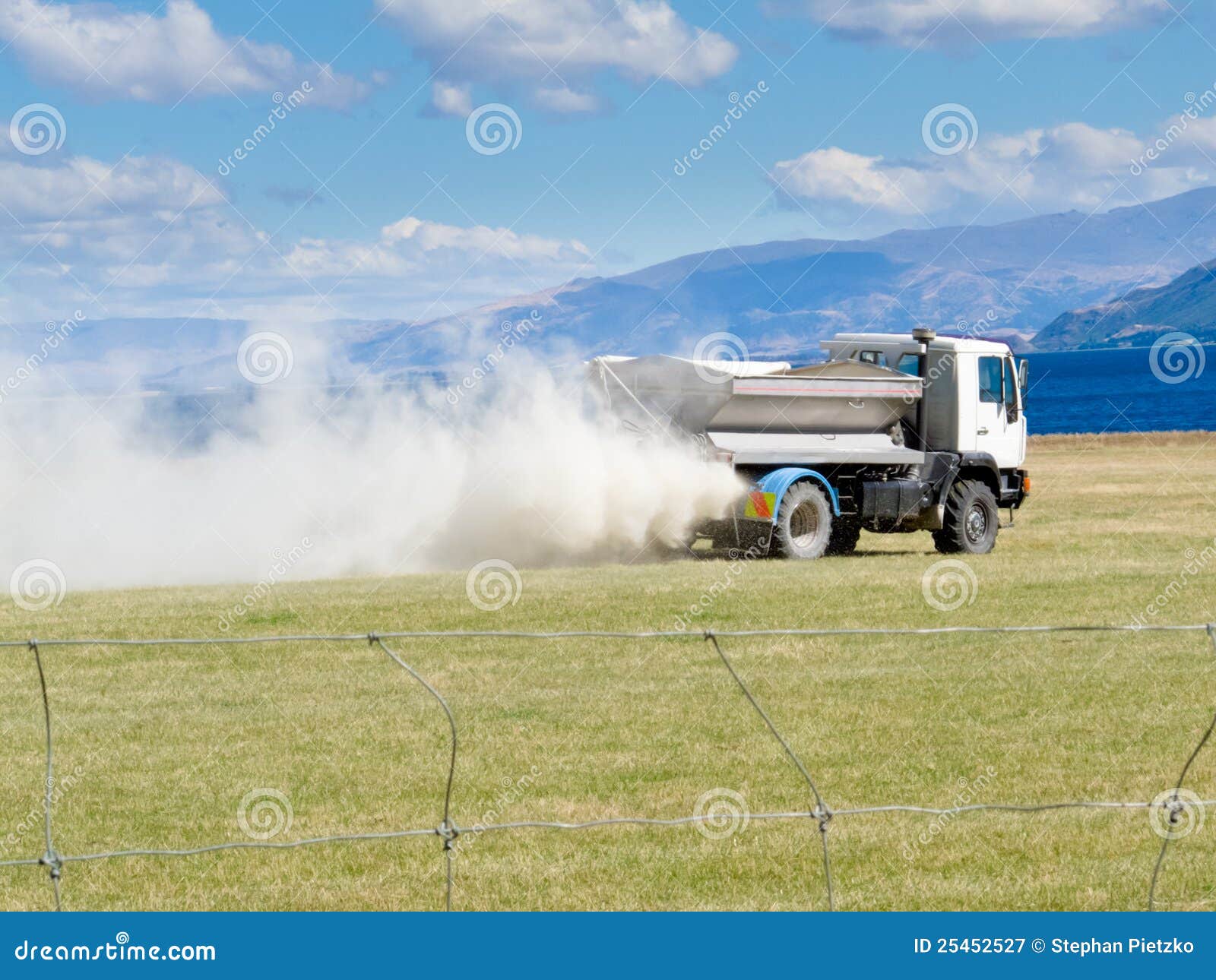 Truck Spreading Fertilizer On Pasture Meadow Royalty Free Stock