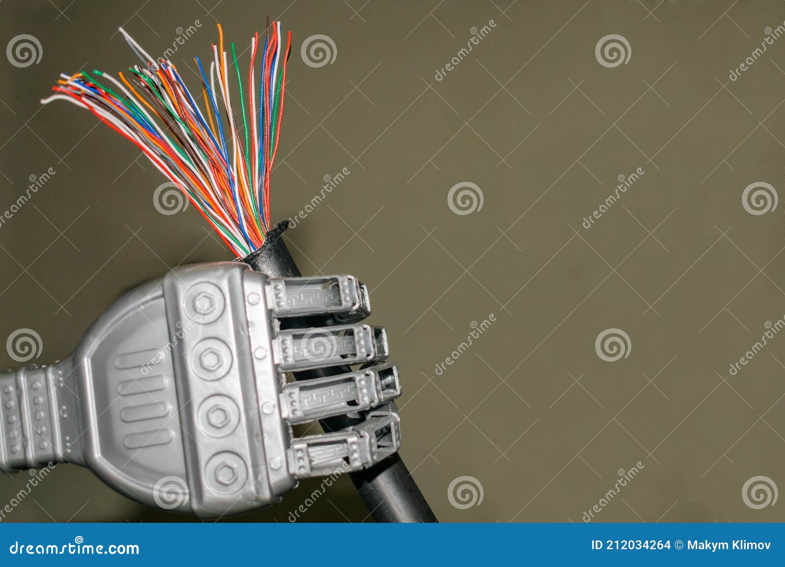 The Trunk Colored Telephone Cable is in the Robot`s Hand. Damaged