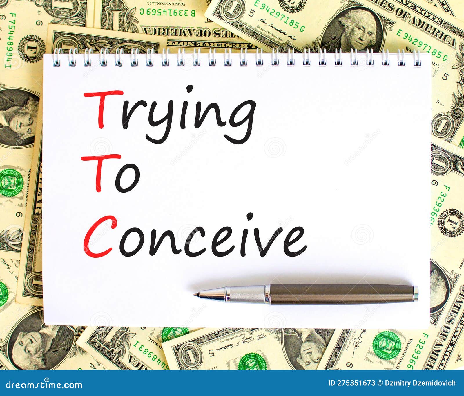 ttc trying to conceive . concept words ttc trying to conceive on white note on a beautiful background from dollar bills. pen