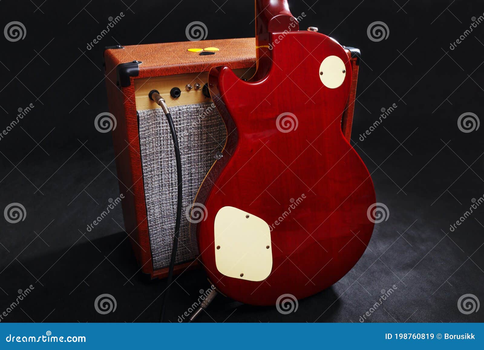 Tube Combo Amplifier for Guitar with Mahogany Guitar on Black