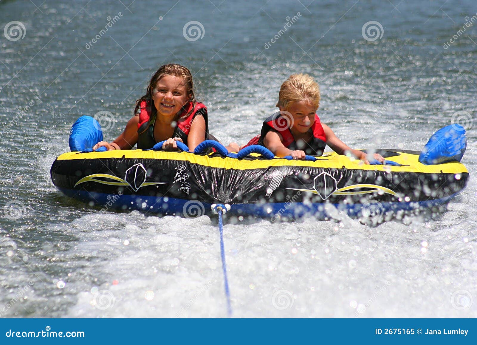 Tubing on the Lake stock image. Image of smiling, holding 2675165