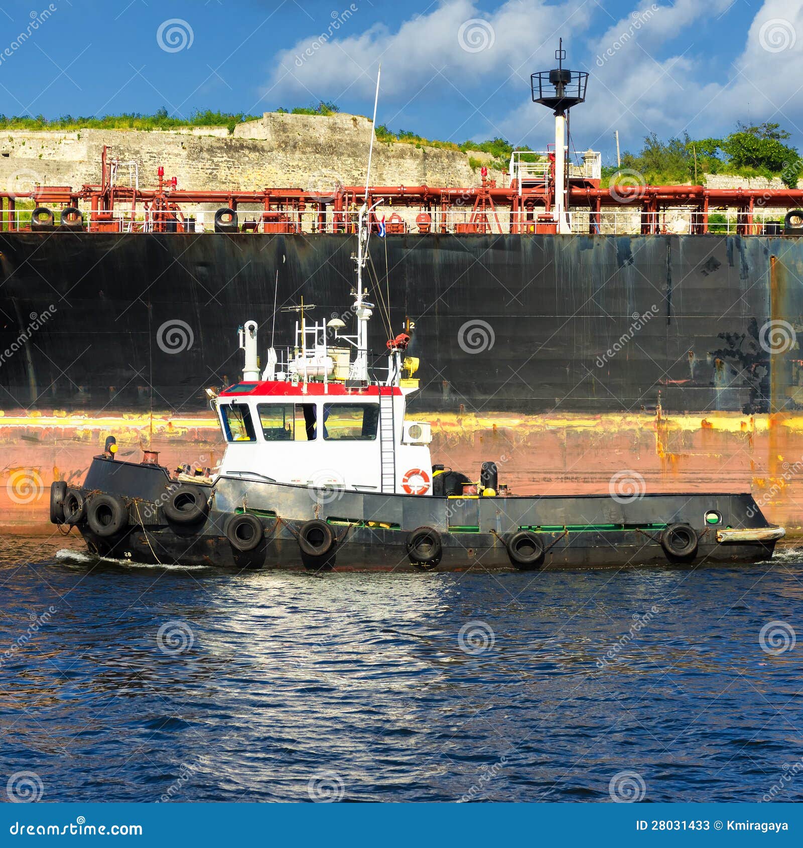 Tugboat Guiding a Huge Cargo Ship Stock Image Image of commercial