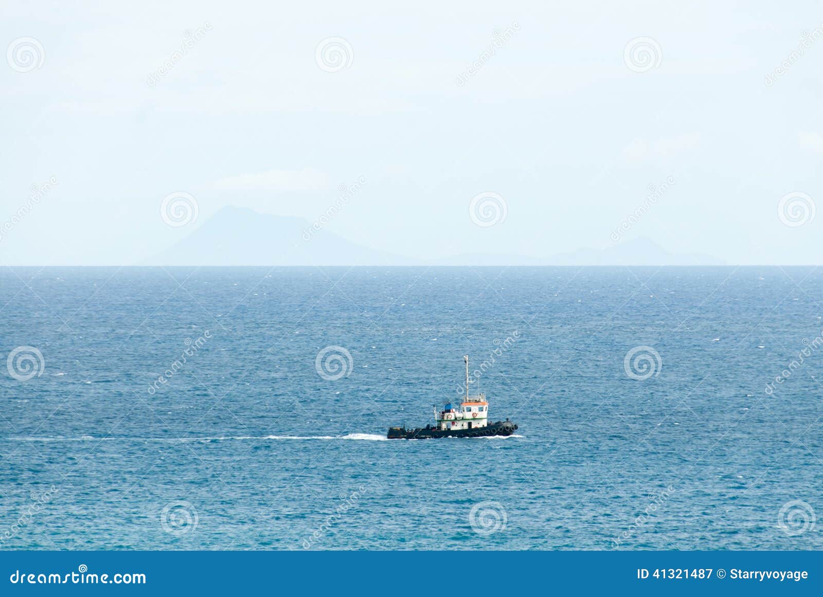 tugboat plows across the caribbean sea.
