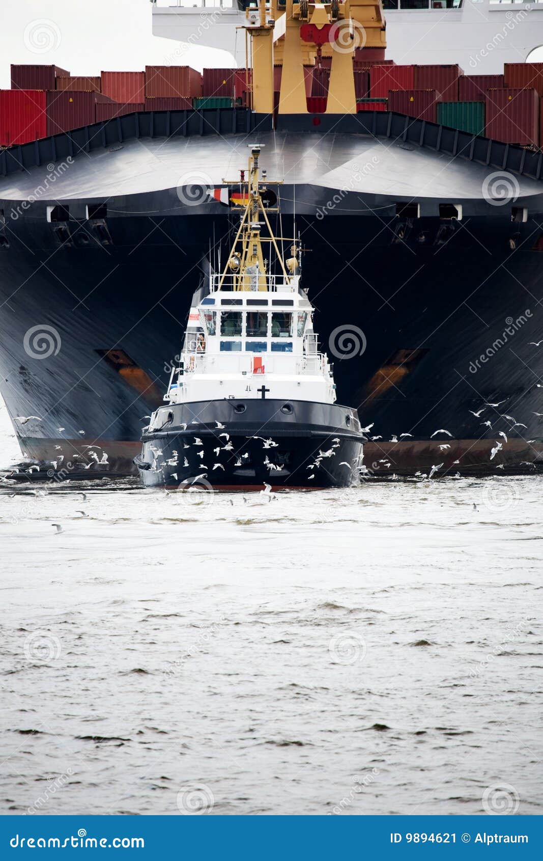 tugboat pulling freighter