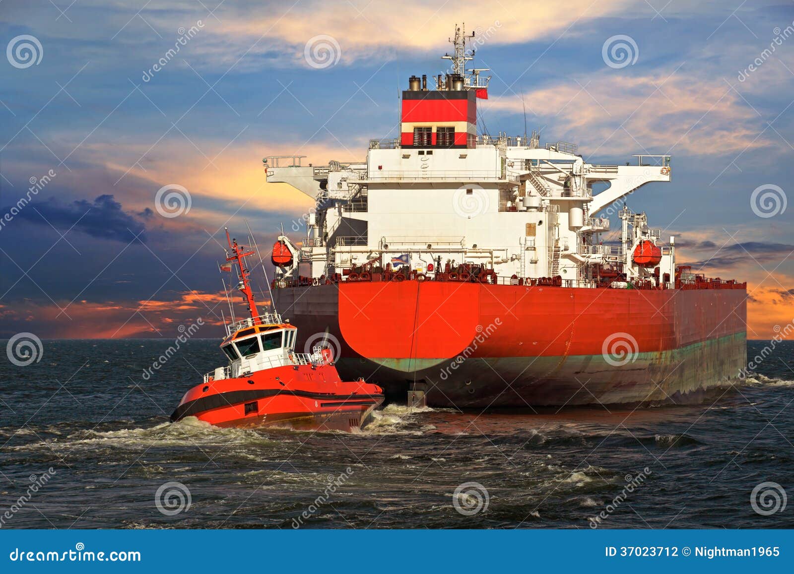 Tugboat towing a ship stock photo. Image of tanker ...