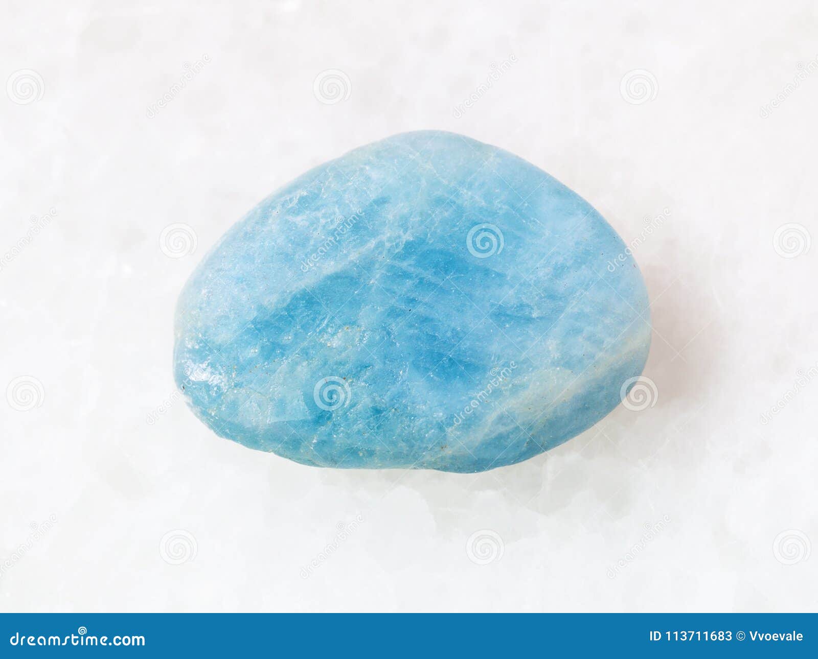 tumbled aquamarine (blue beryl) gem stone on white