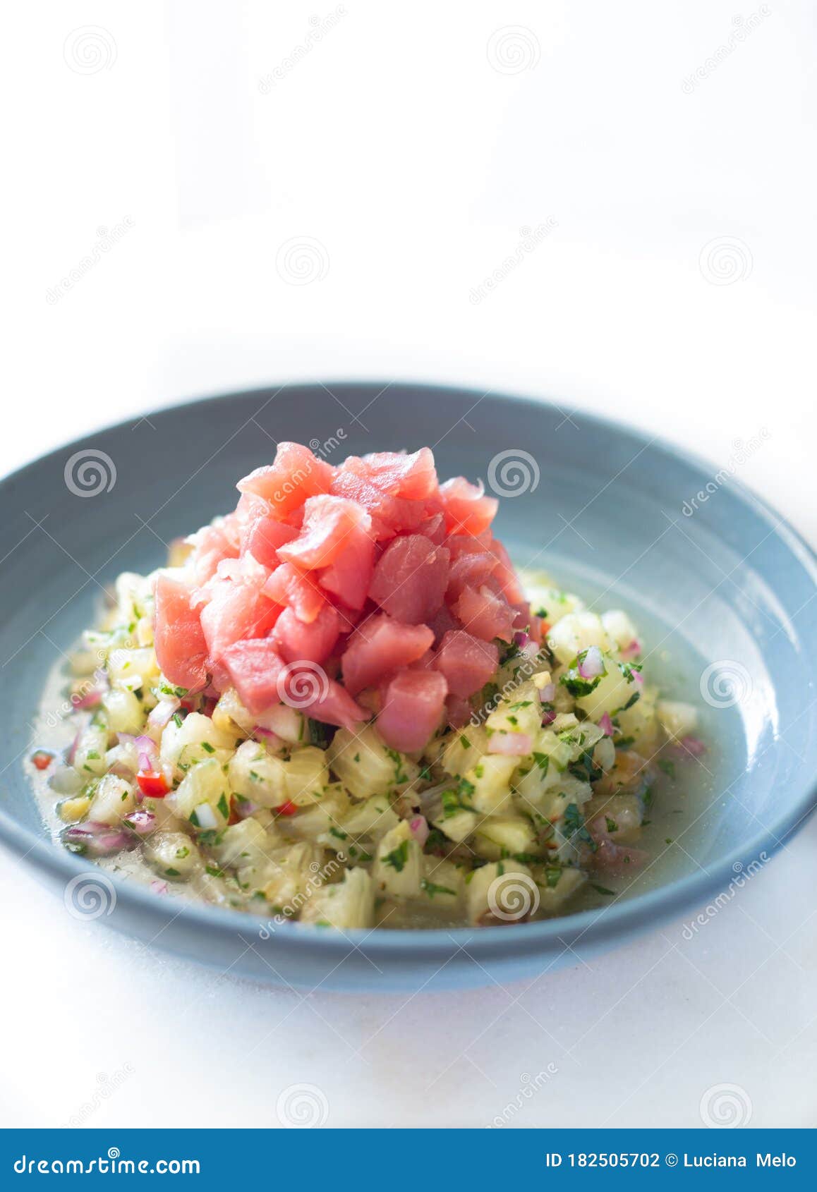 Tuna and Pineapple Brazilian Ceviche on a White Surface and Blue Dish