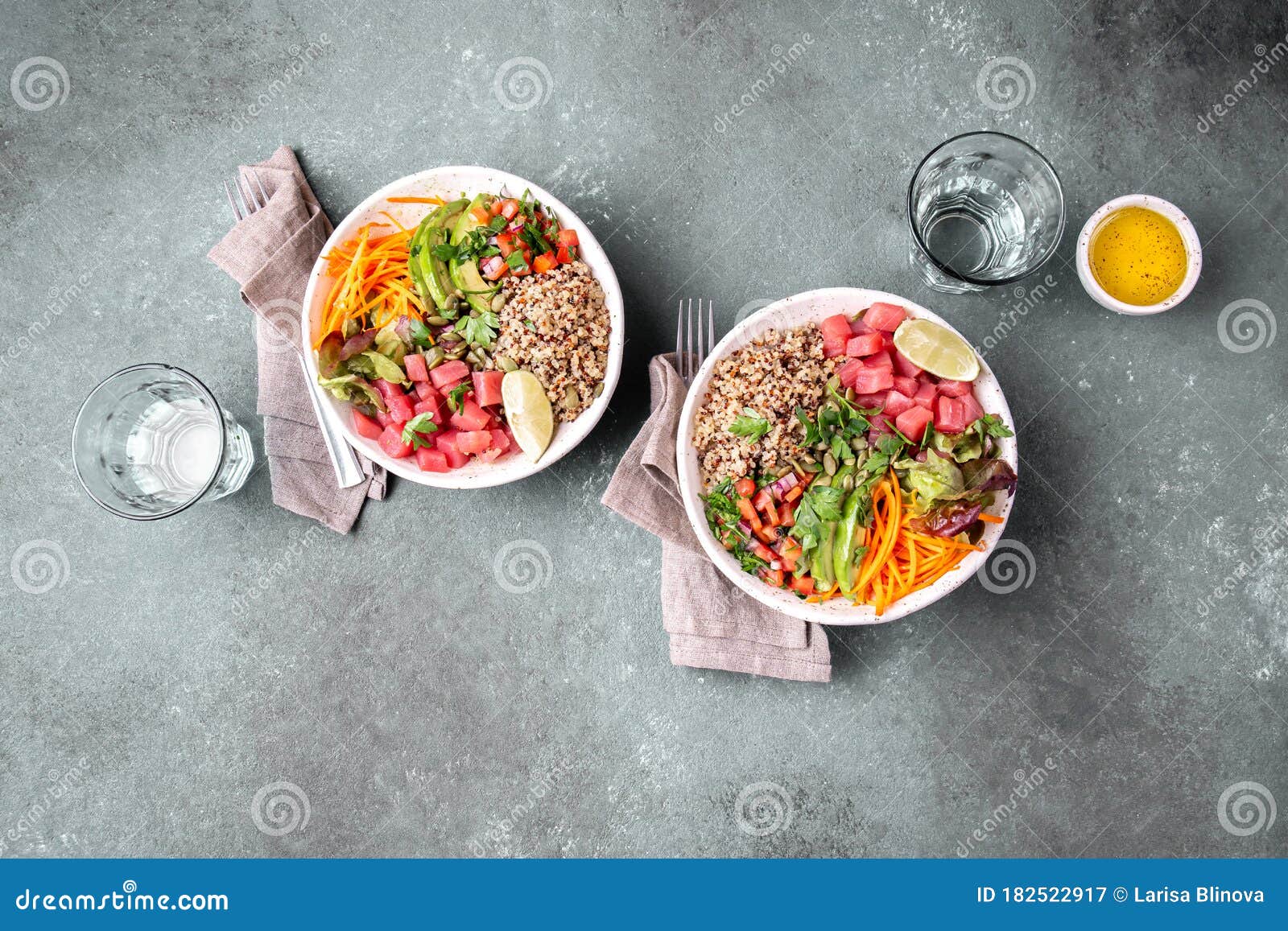 tuna poke bowl with quinoa and vegetales. budda bowl. quinua tuna salad on gray background