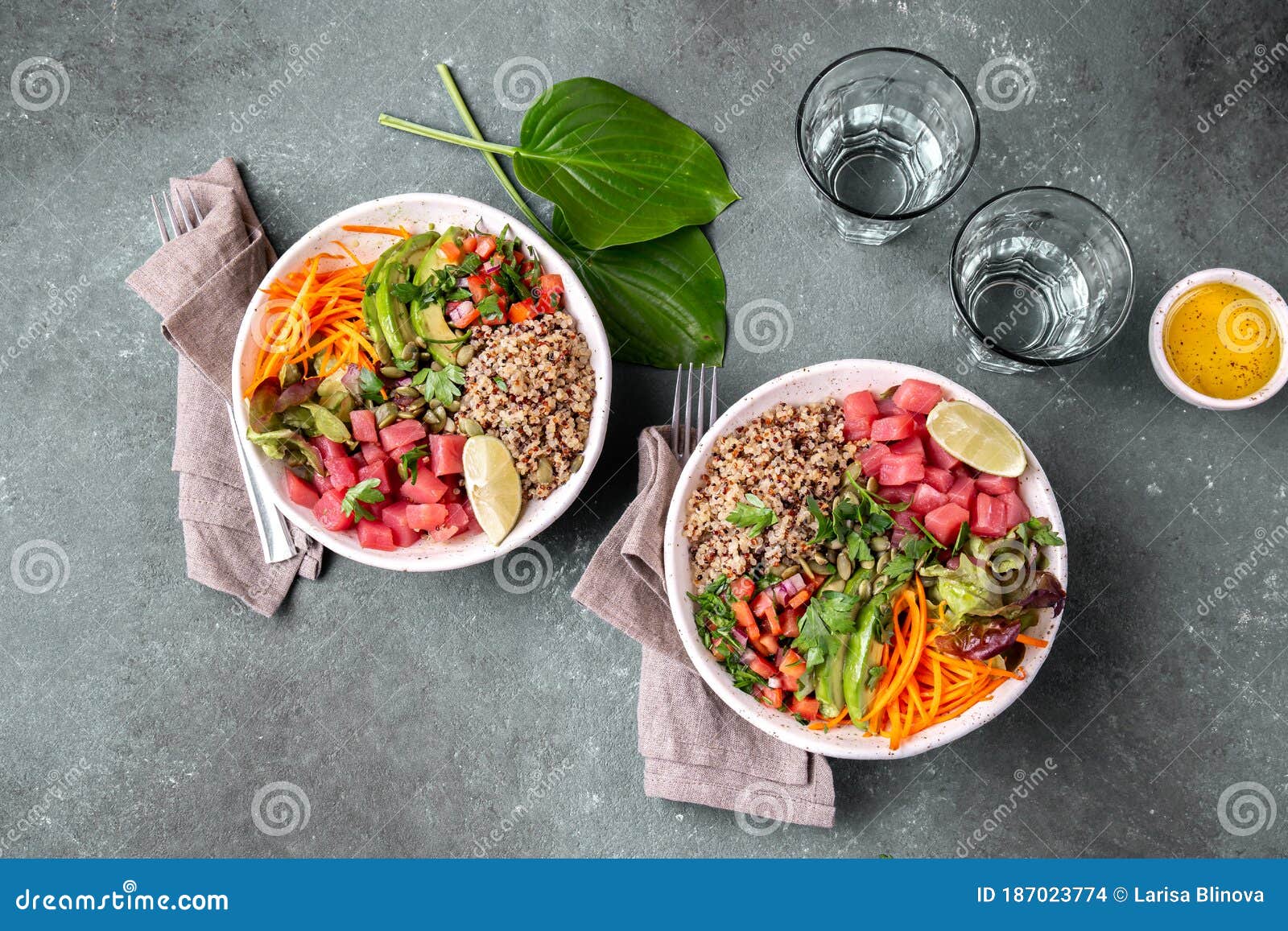 tuna poke bowl with quinoa and vegetales. budda bowl. quinua tuna salad on gray background