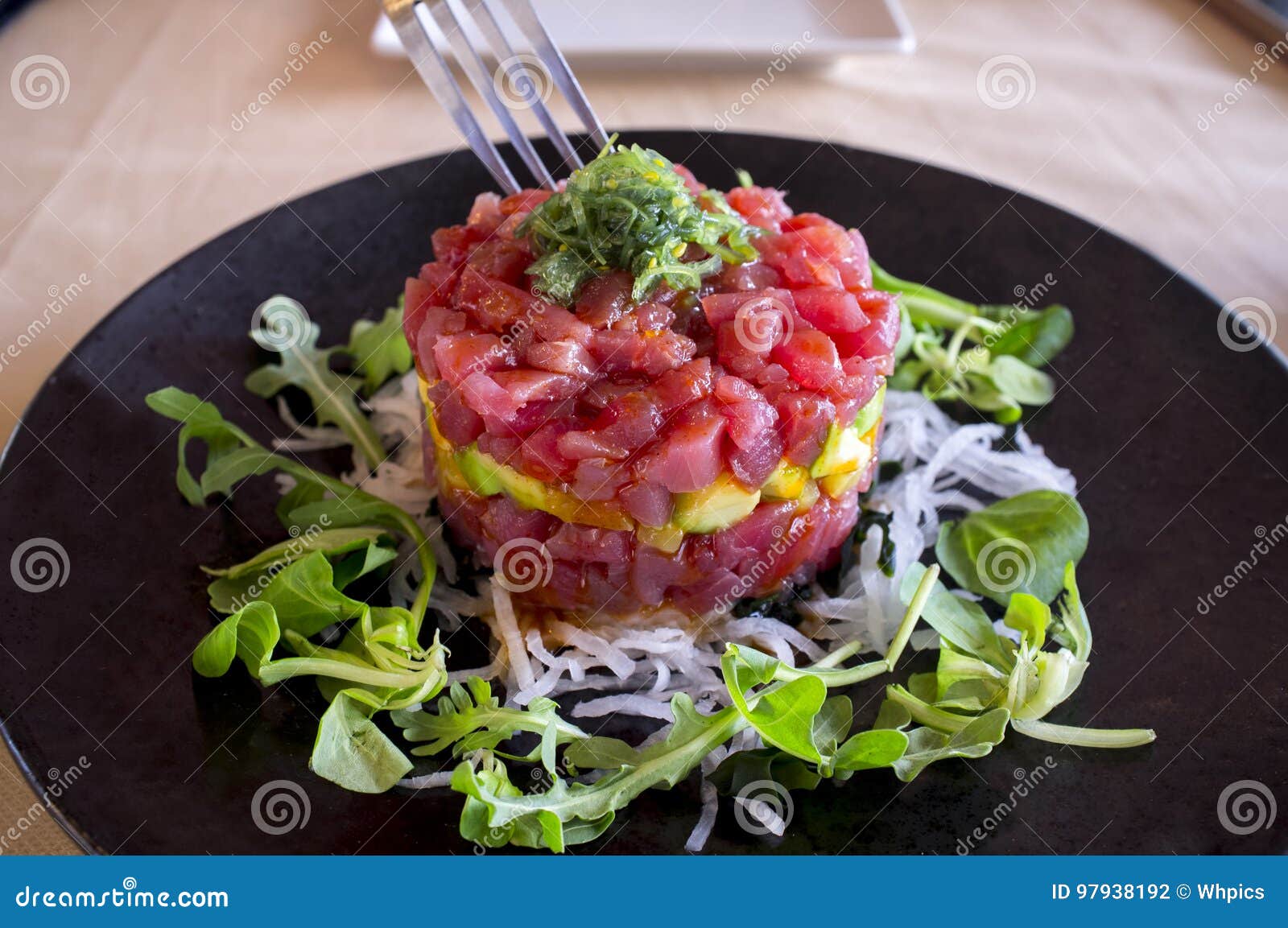 Tuna tartar dish with fork stock photo. Image of recipe 97938192
