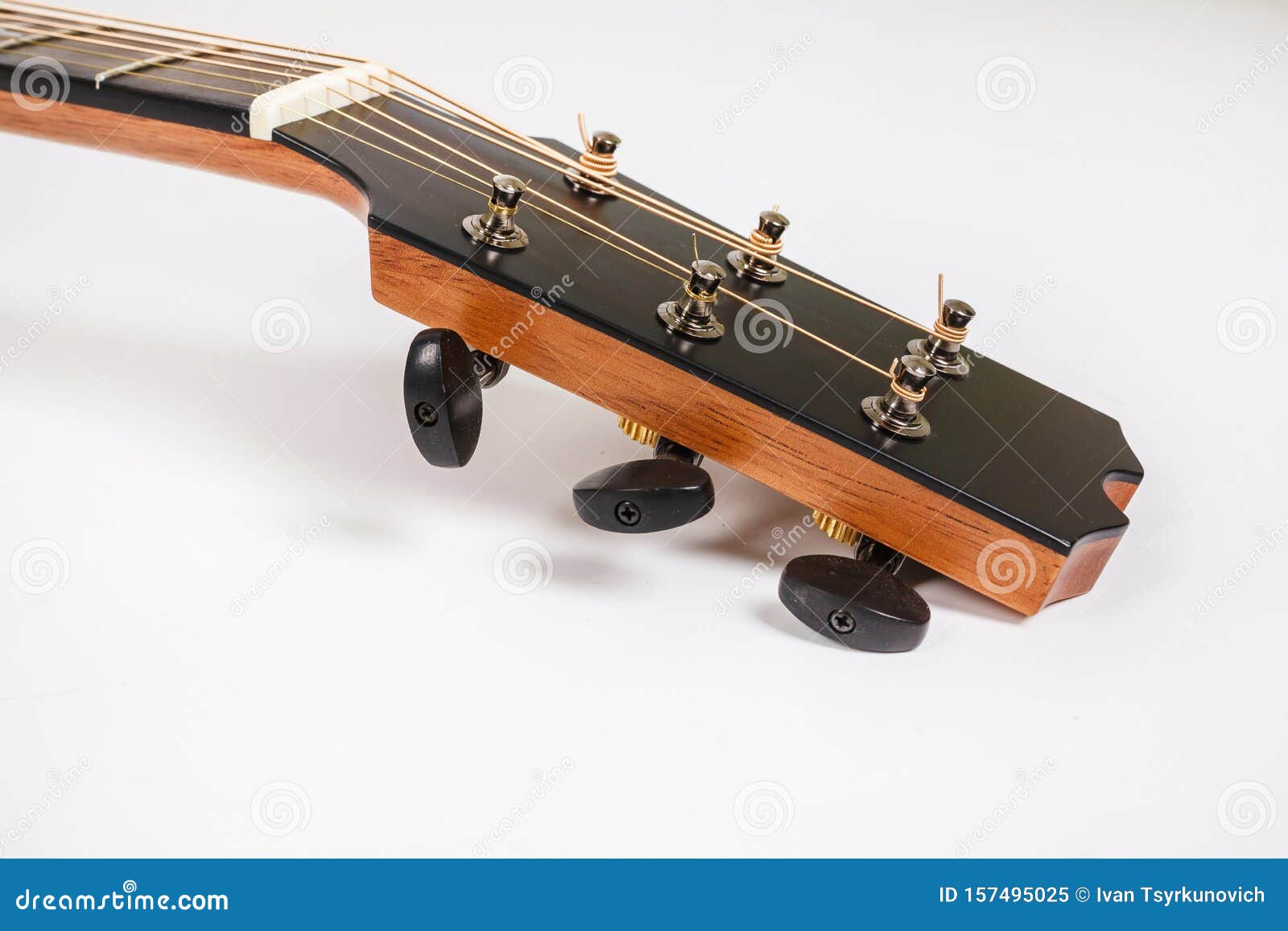 Tuning Pegs on Wooden Machine Head of Six Strings Guitar on White